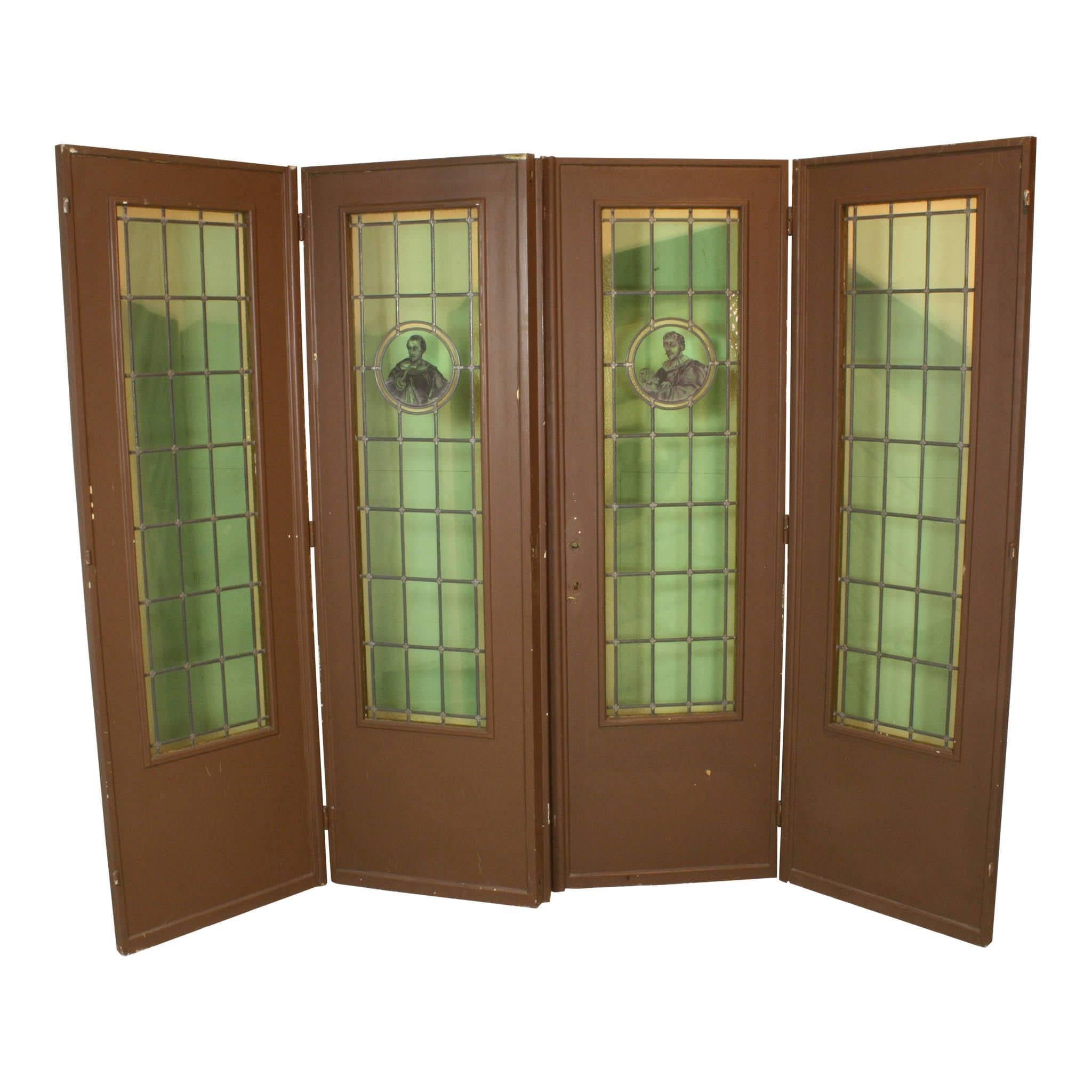 Twenty-one green, stained glass panels with a border of yellow, stained glass trim are featured on each of these folding doors. Two interesting gentlemen are painted inside the circles of the two interior doors on this set of four. One holds a