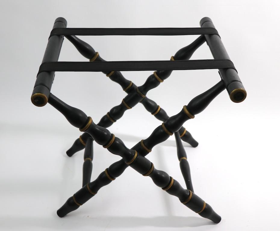 Muscular turned wood form luggage rack having turned legs, in black paint with gold paint trim. Very fine, original condition, clean and ready to use.