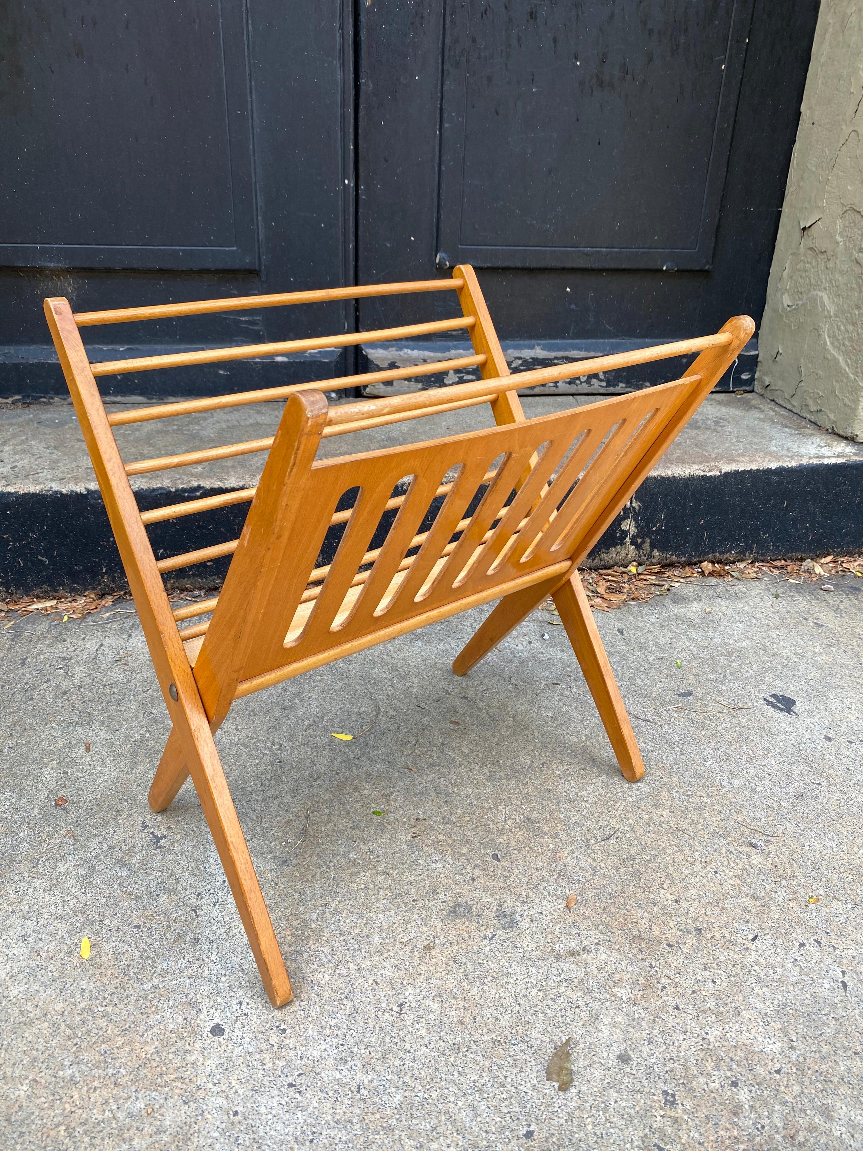 1970's folding magazine rack. 1970's Produced in Yugoslavia. Nice design with wood dowels and a plywood cut out panel.