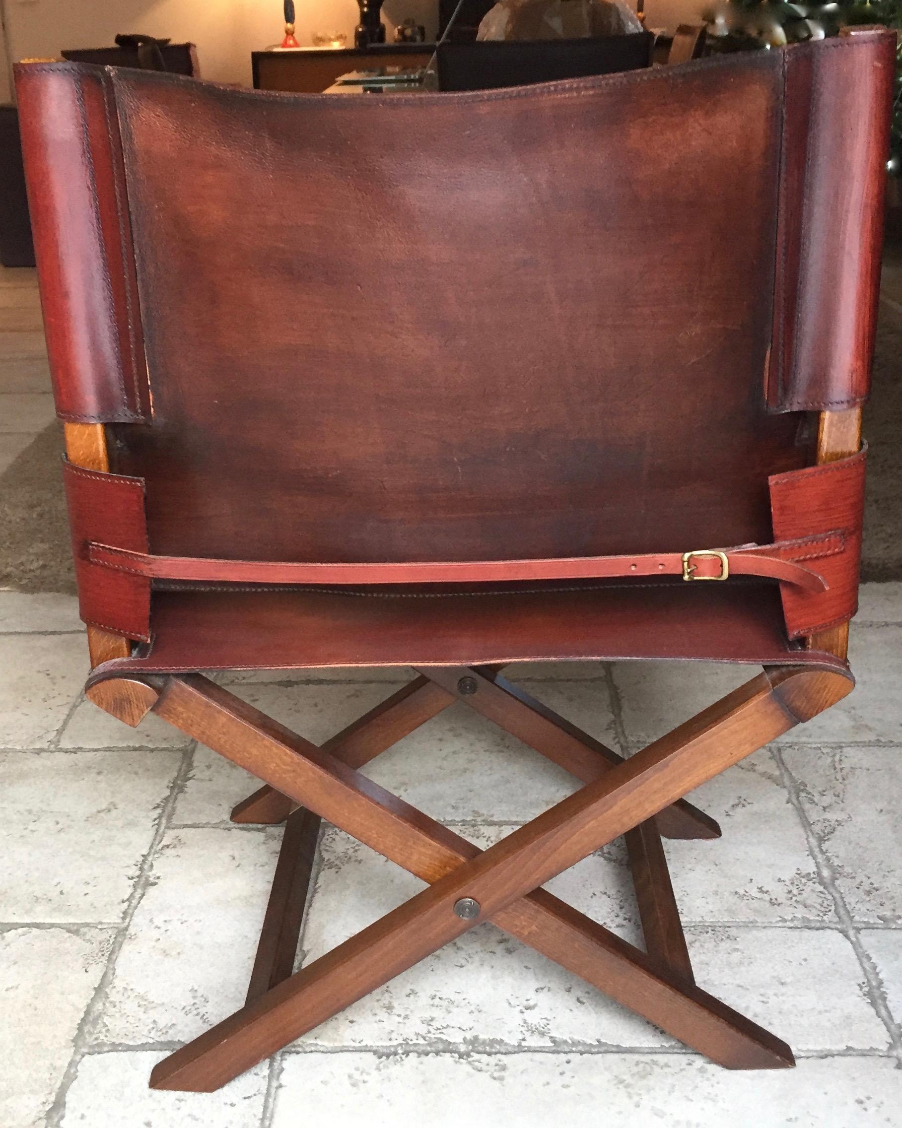 Rare modern folding armchair, seat and backrest in burgundy leather, reproduction of the Napoleon Bonaparte campaign armchair by Grange, a French house founded in 1904. Armchair Numbered 1095.

 