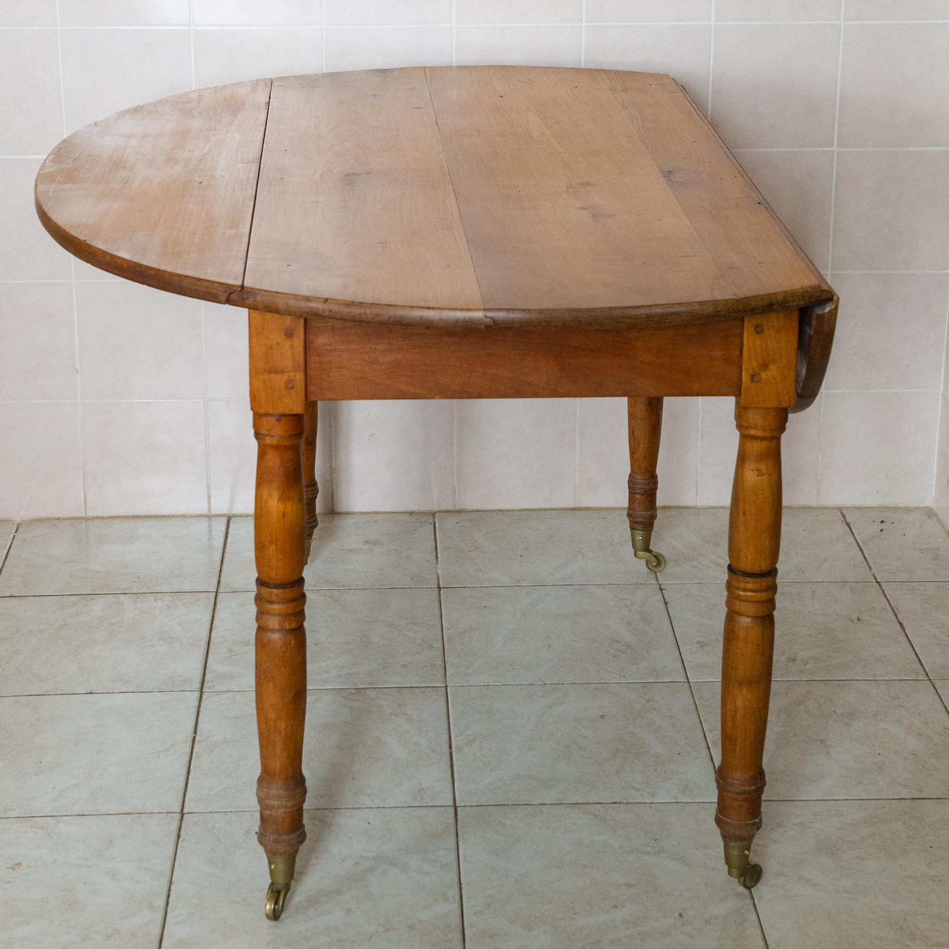 M/1839 - Folding oval walnut table with wheels: simple, useful, elegant in simplicity. 
When not used open, it folds to one side and becomes a comfortable table for breakfast.
When not in use, the two side parts are folded and it becomes a console
