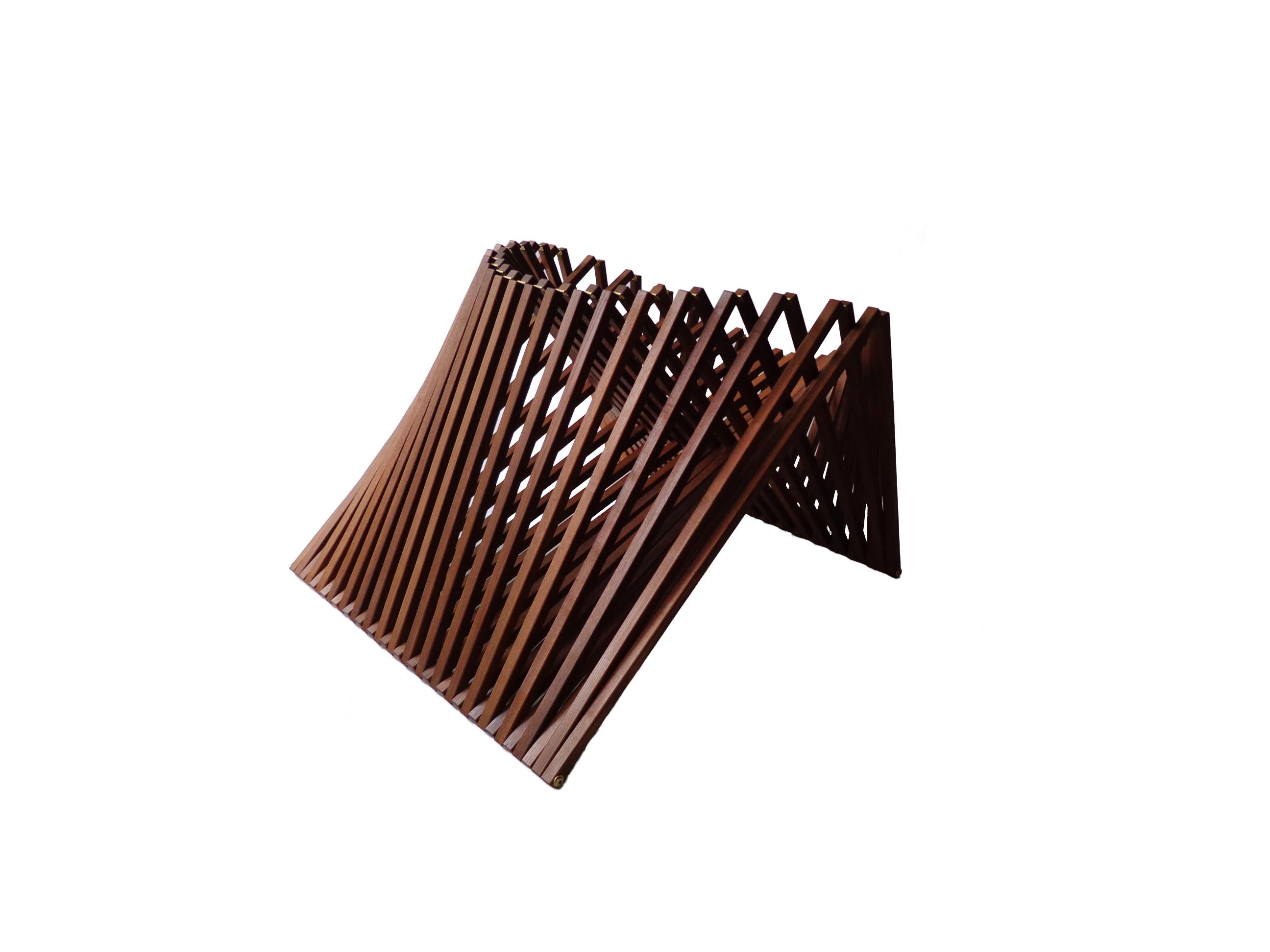 The Rising Chair emphasizes the natural shape an object can make by transforming itself. The rhythm of the wooden beams gives the chair an organic shape.

Dutch designer Robert van Embricqs’ furniture gives poetic form to function. Finding