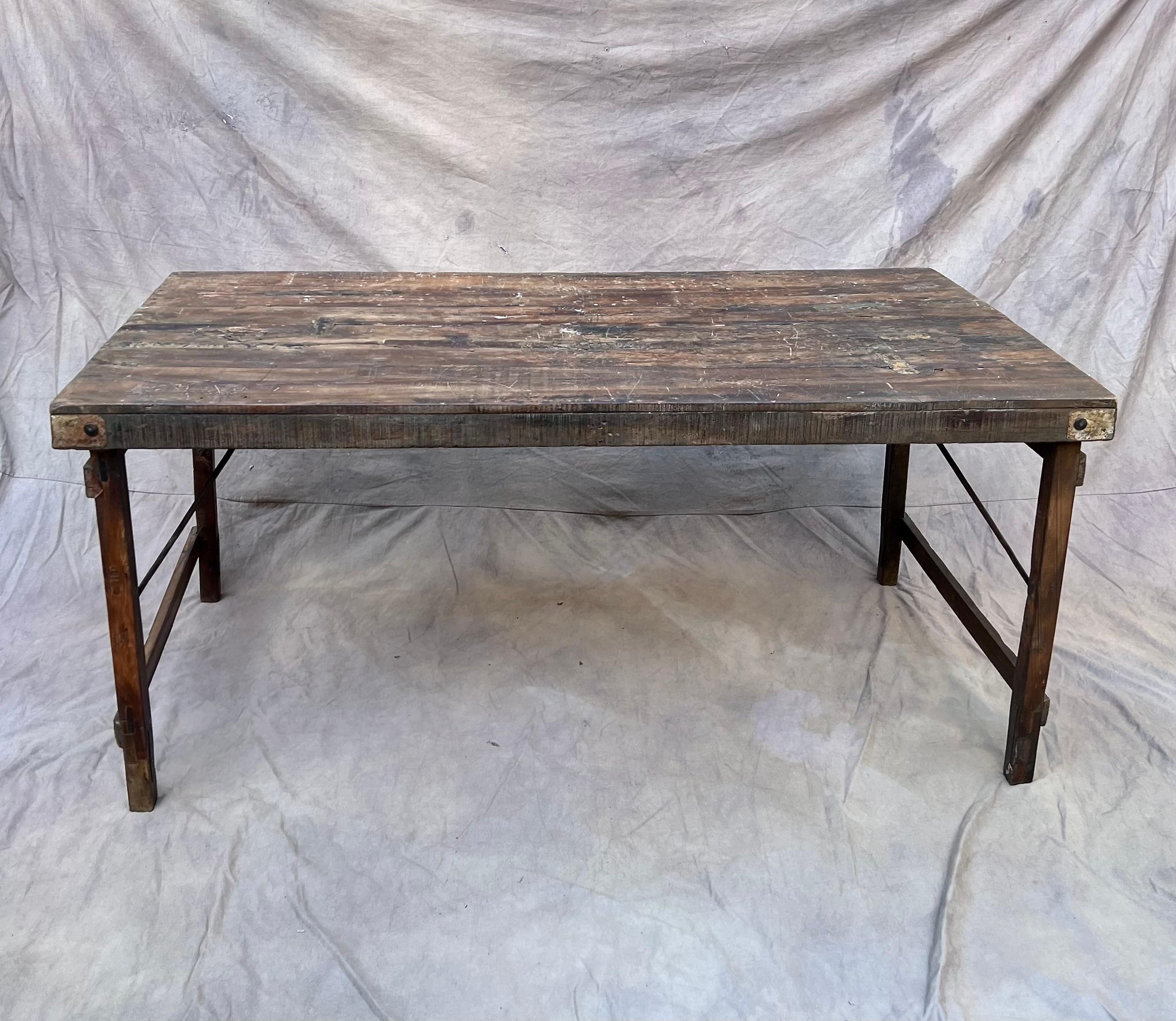 Vintage Belgian folding farm table can be used as a table or desk. Looks great in the garden for a dinner party and brings some wabi-sabi sophistication to the indoors. 

This table folds up easily to be less than 4