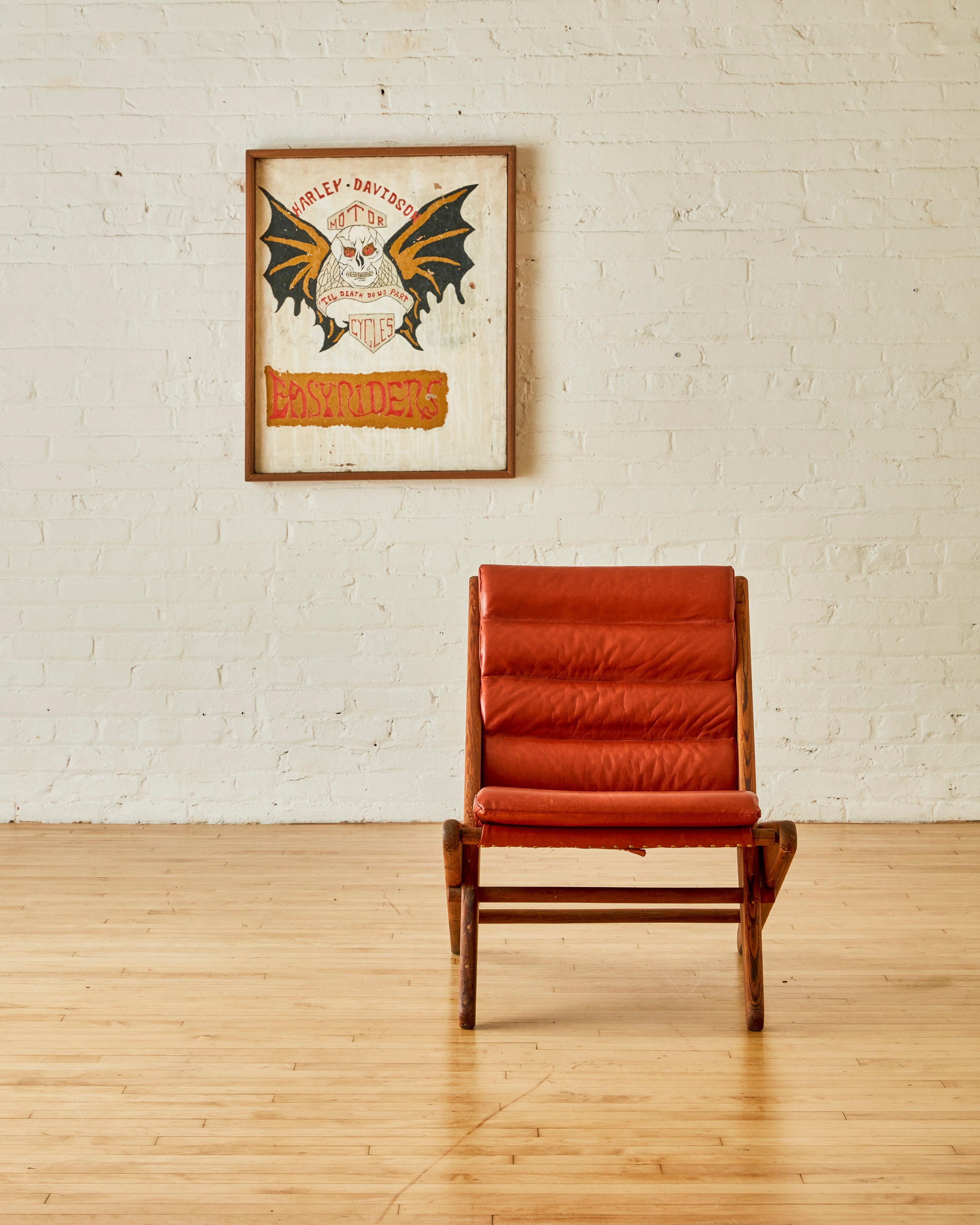 Folding Scissor Chair by Ficks Reed, newly reupholstered in saddle leather with bolster upholstery.

