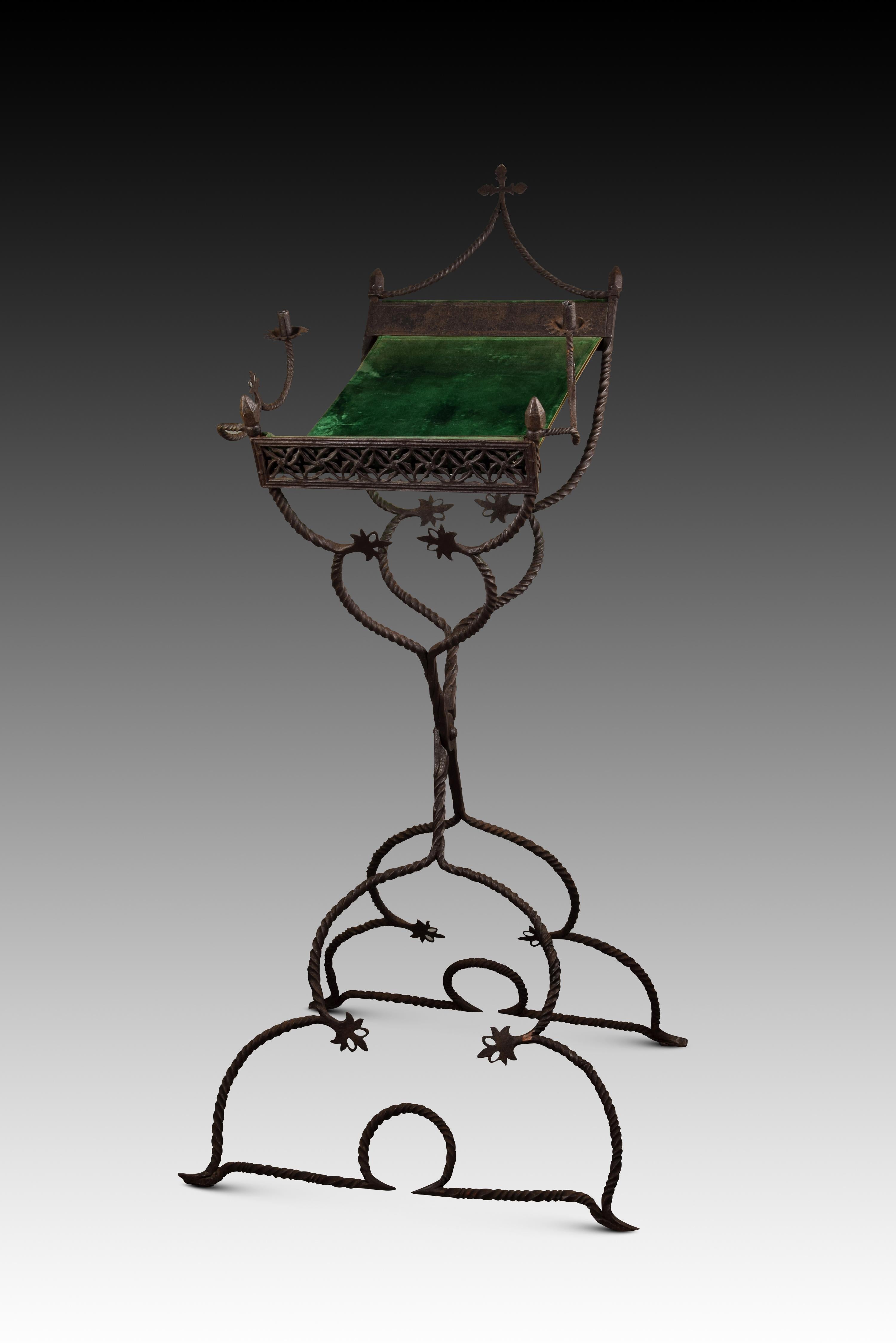 Folding standing lectern in wrought iron and fabric, Spain, 16th century. 
The two scissor joined legs that support the lectern present architectural decorative elements (pointed arches) and highly stylized plants. The upper zone shows some bands of
