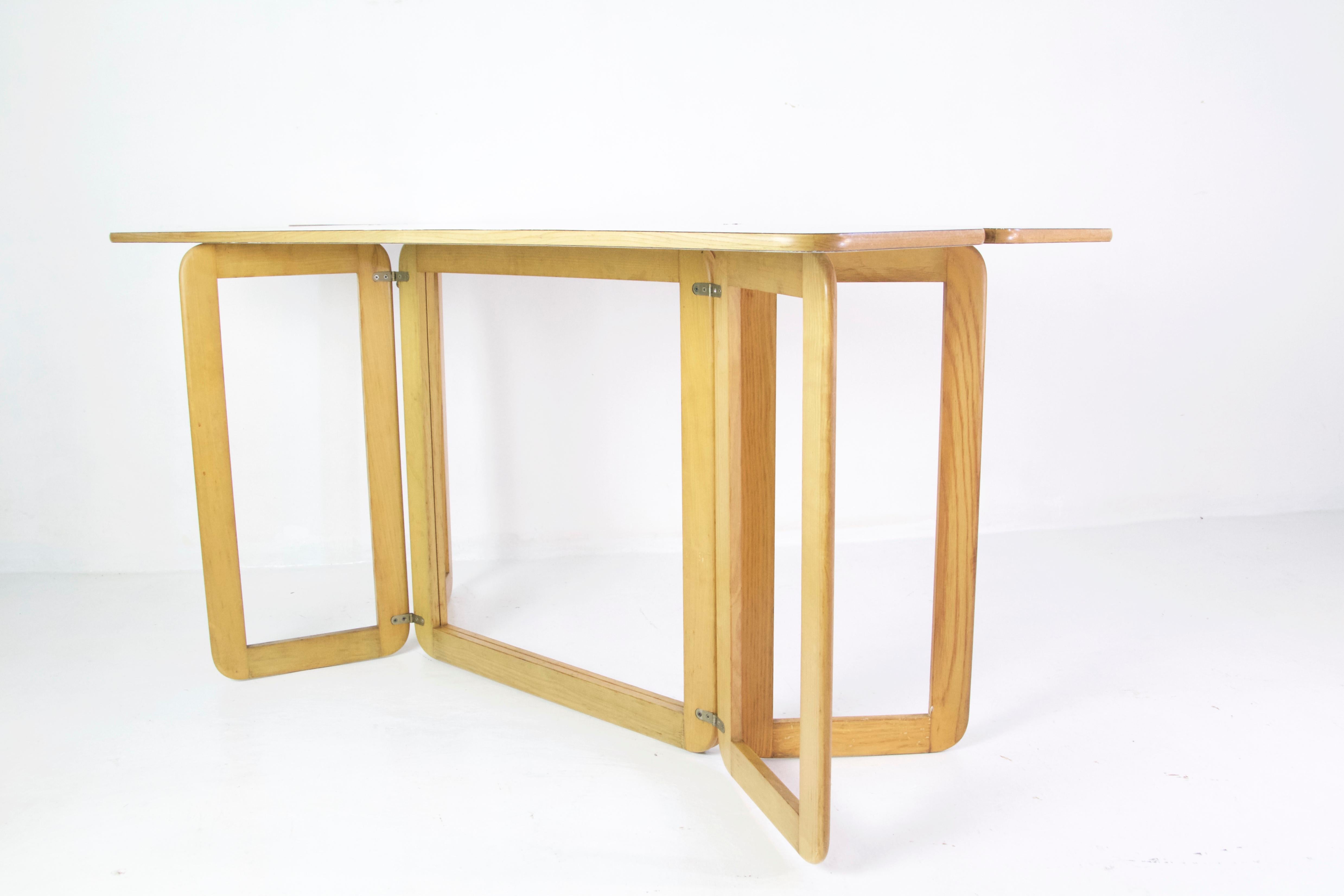 Table by designer Giovanni Offredi and produced by MC Selvini, 1970s. Works excellent as a freestanding table, desk or against a wall and it can be used in its full width or as a console with the top folded. The construction is fully foldable.