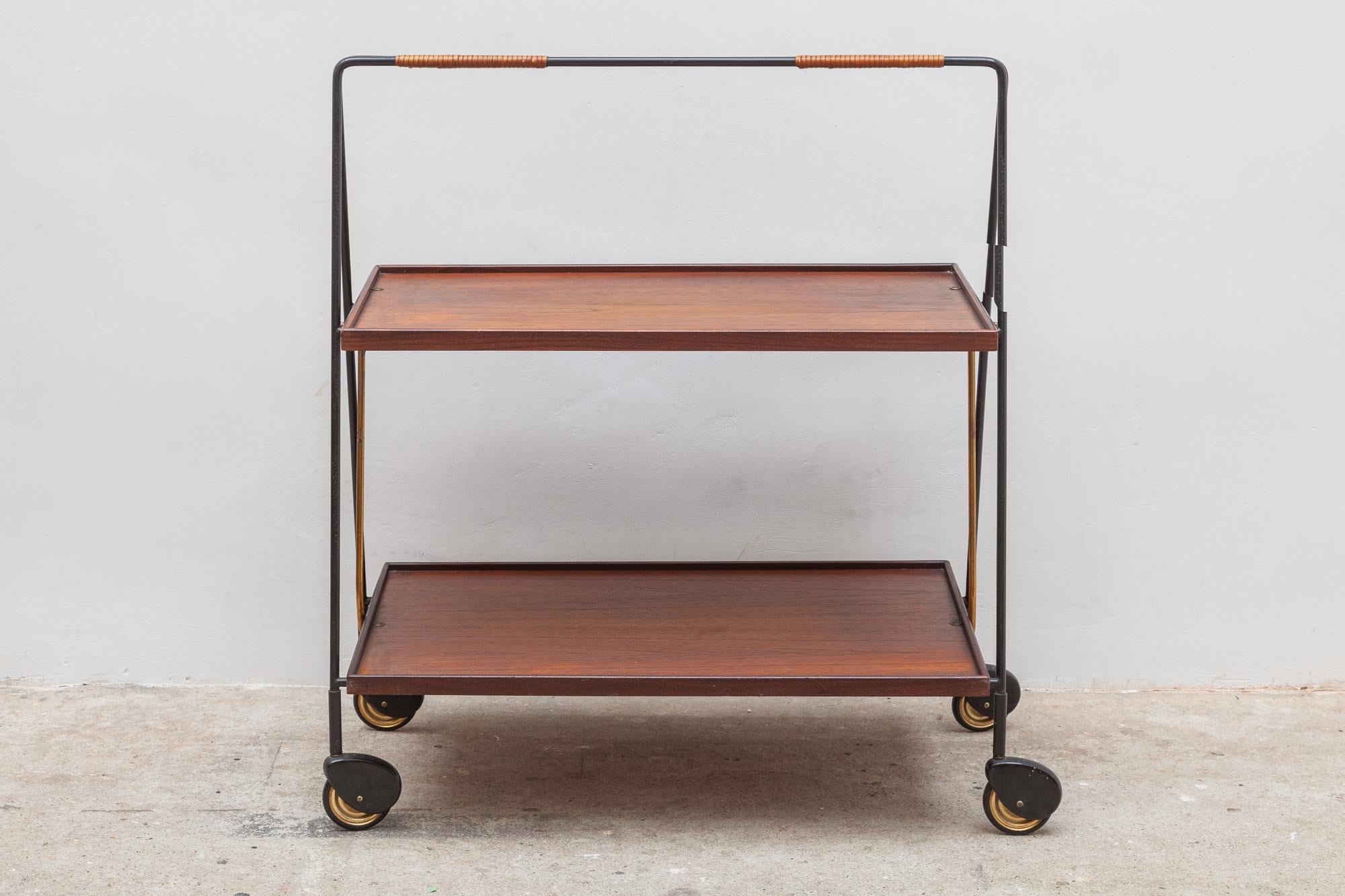 A beautiful teak folding trolley with a wrought iron frame, stable on four wheels and practical to use with a beautiful patina.