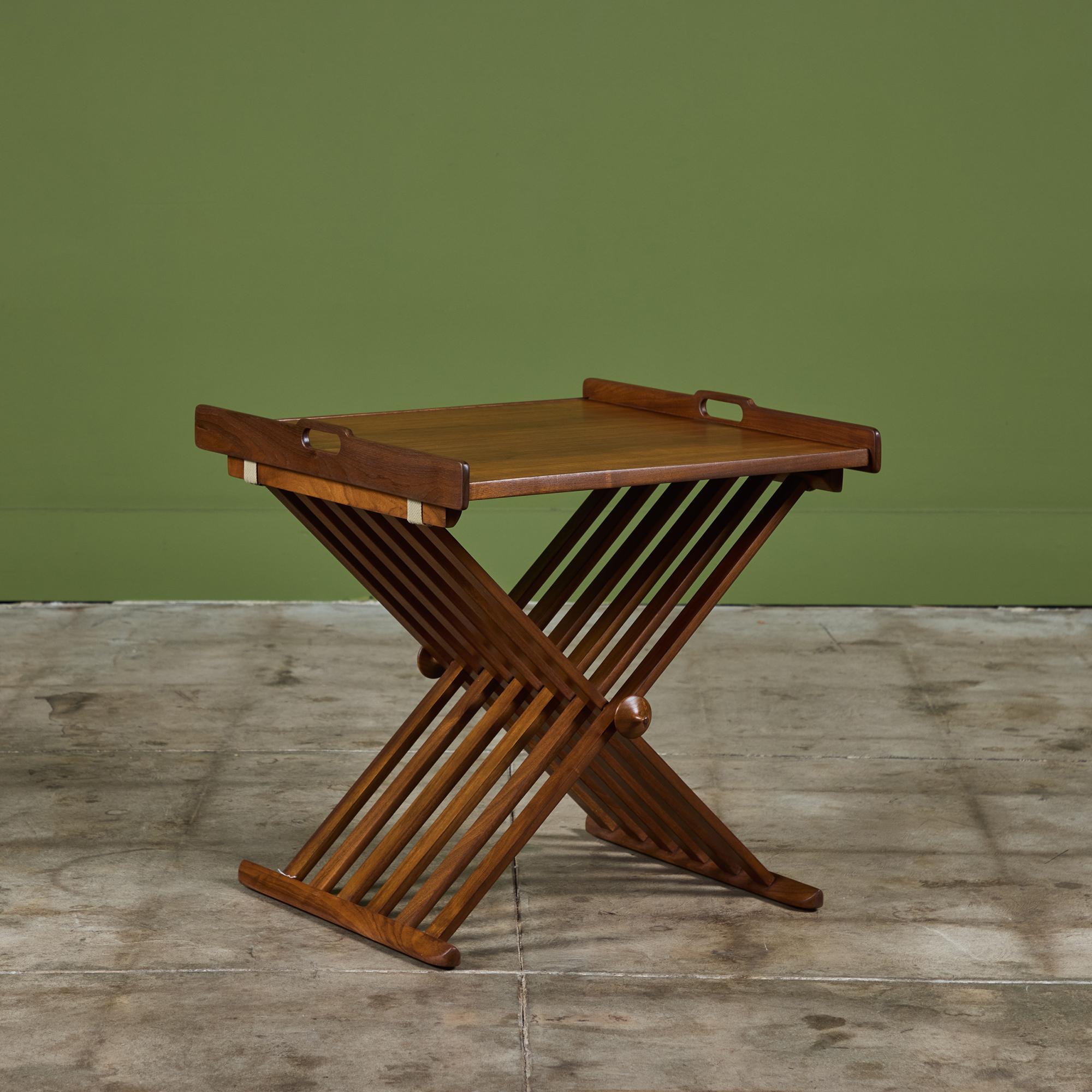 Walnut folding table by Kipp Stewart and Stewart MacDougall for Drexel c.1960s, USA. The rectangular folding table features a slatted x-base design with removable tray showcasing handles on two sides.

Dimensions
20