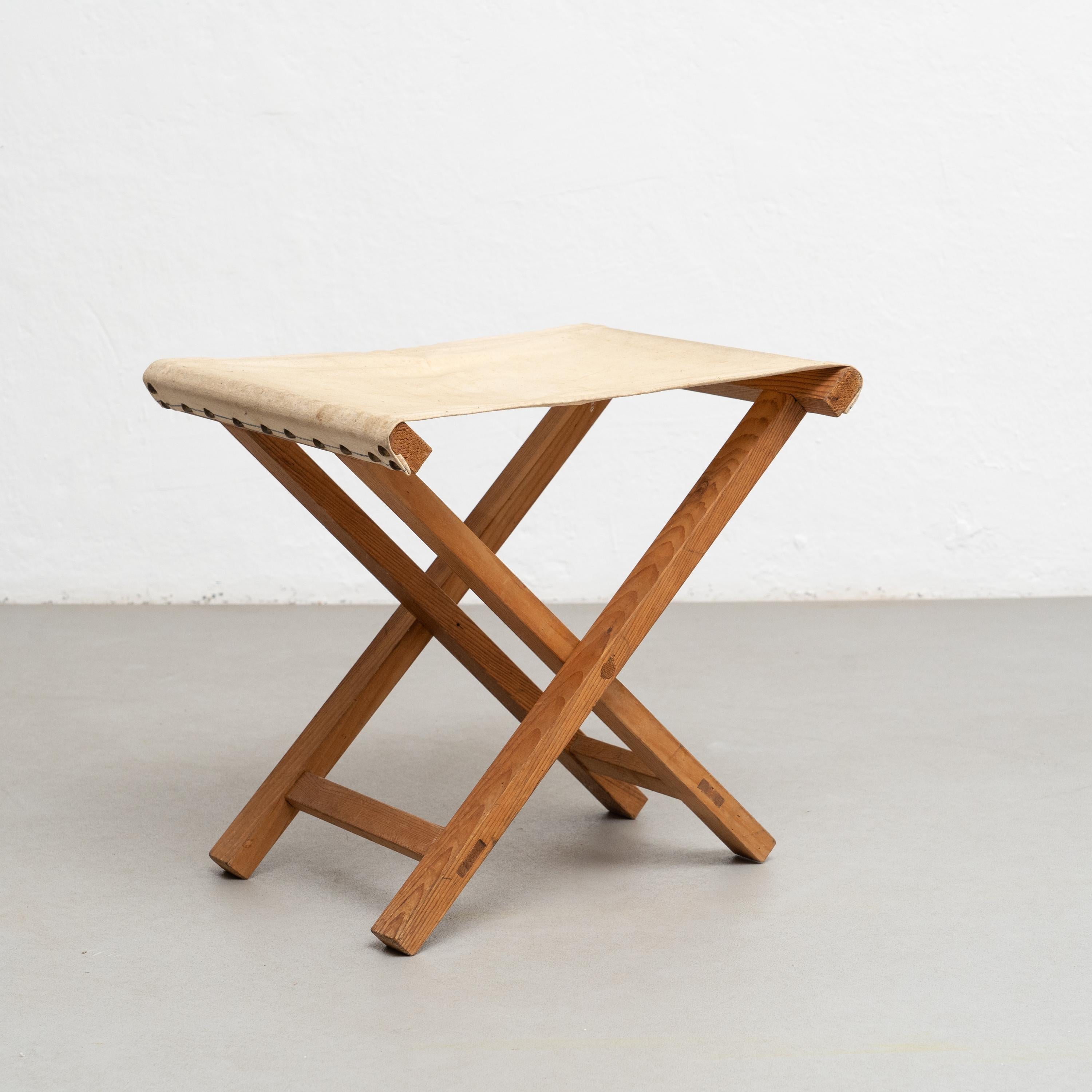Folding wood and Fabric Stool, circa 1960.    By unknown artisan in Spain, circa 1960.    In good original condition, with minor wear consistent with age and use, preserving a beautiful patina.    Materials:  Wood.  Fabric.