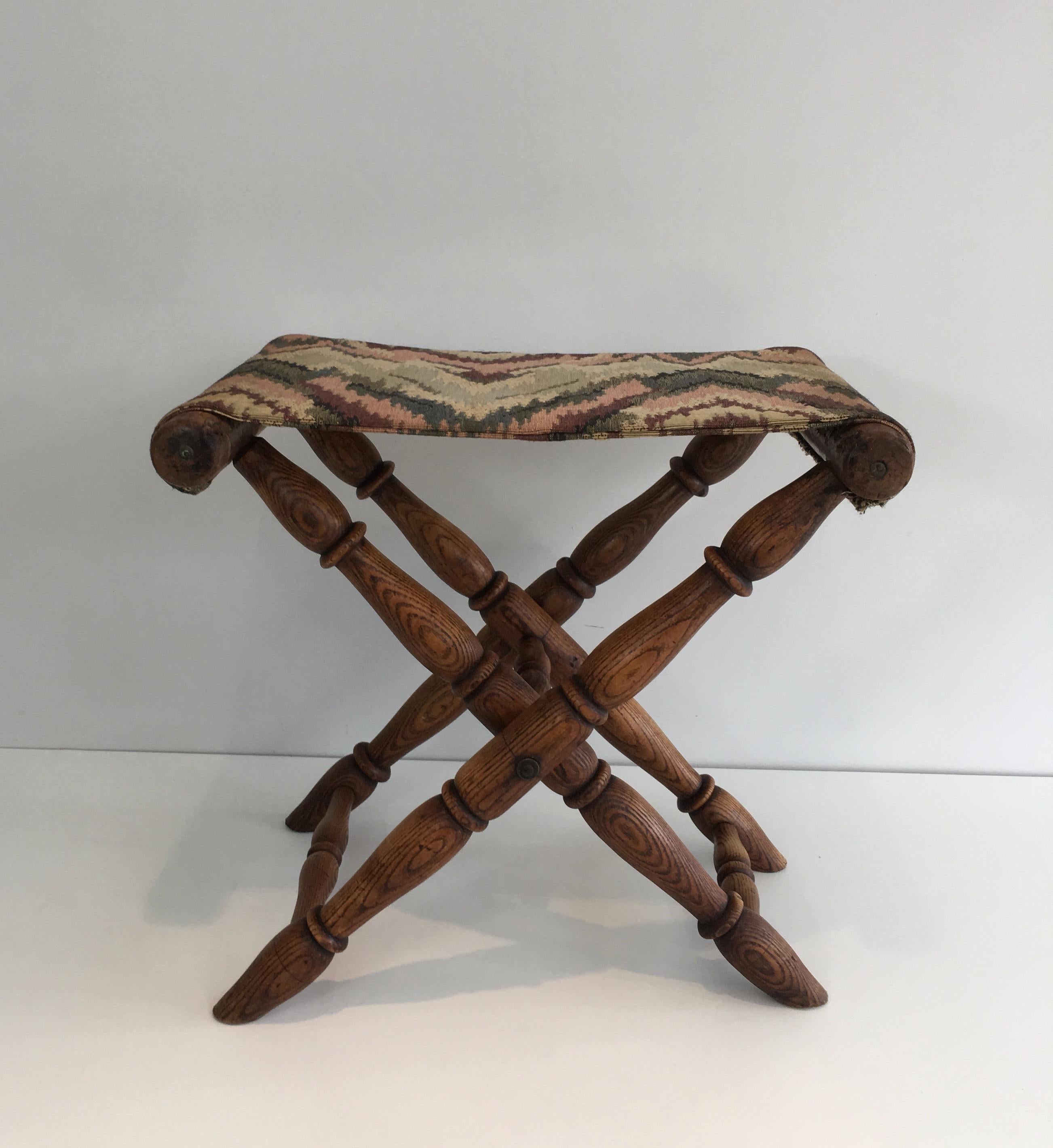 This folding stool is made of a wooden base and of tapestry. This is a French work, circa 1900.