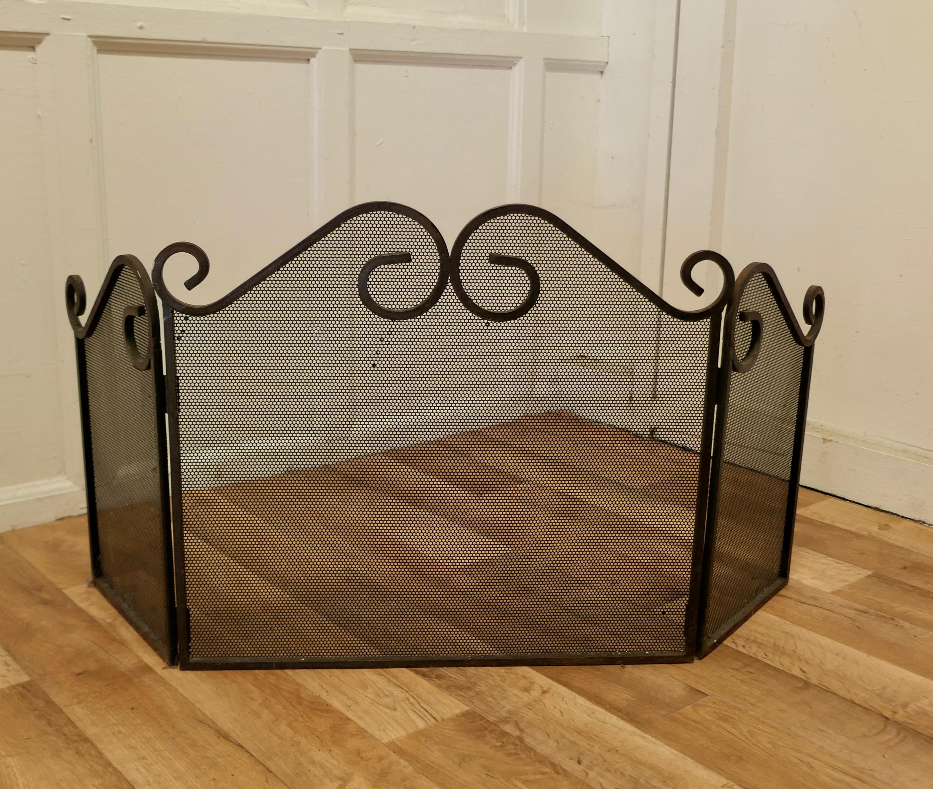 Folding wrought iron fire guard for inglenook fireplace.

This is a long Fireguard, it would suit a traditional Inglenook fireplace or any large fire.
The guard has a decorative wrought iron decoration over heavy inset mesh.
The guard is in good