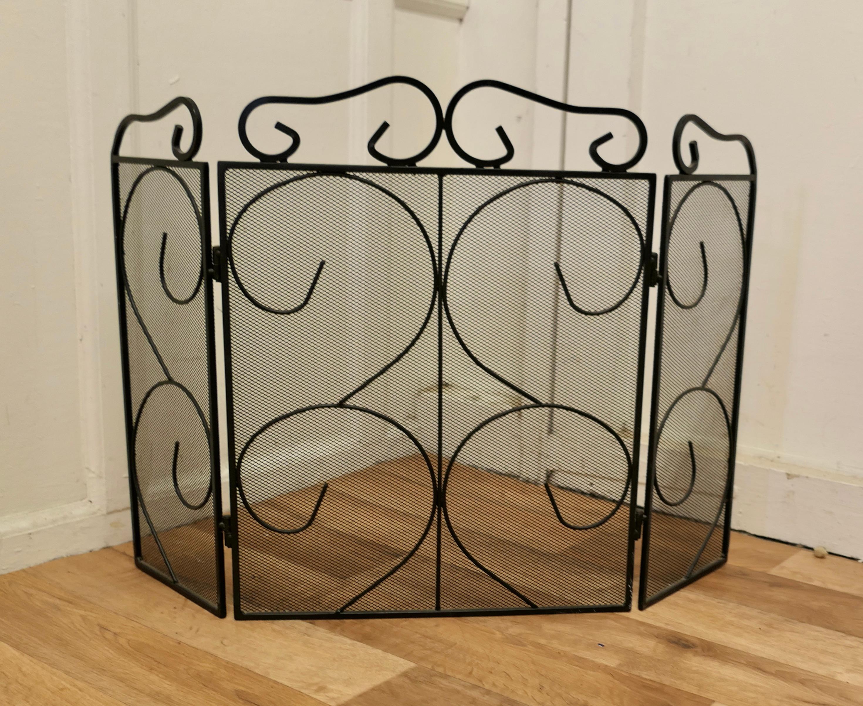 Folding Wrought Iron Fire Guard for Inglenook Fireplace

This is a good Fireguard, it would suit a traditional Inglenook fireplace or any fire 
The guard has a decorative wrought iron decoration over heavy inset mesh 
The guard is in good