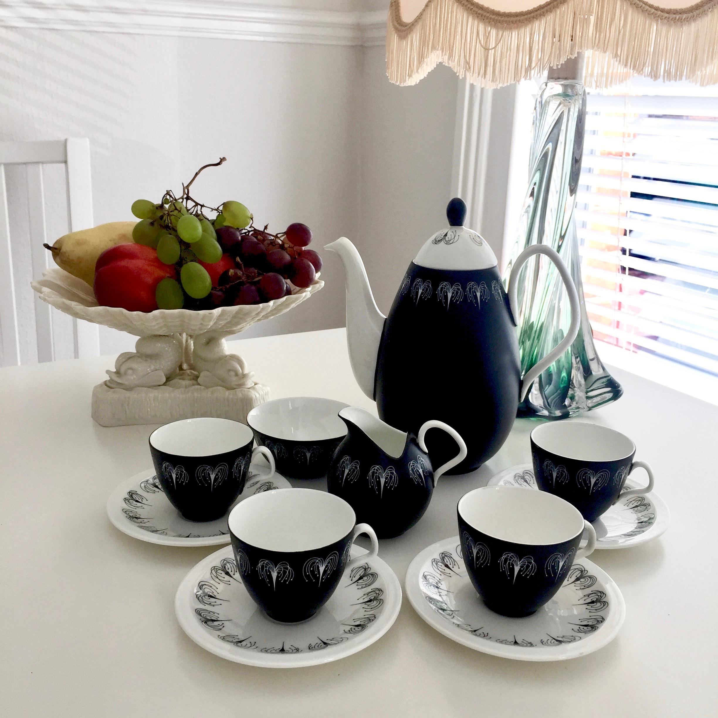 This is a stunning Midcentury Modern coffee service serving four, made by E. Brain, also called Foley, in 1957. The shape of this service was designed by Donald Brindly and the black and white decoration called 