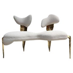 Fauteuil Folia en structure dorée laiton et tissu blanc doux