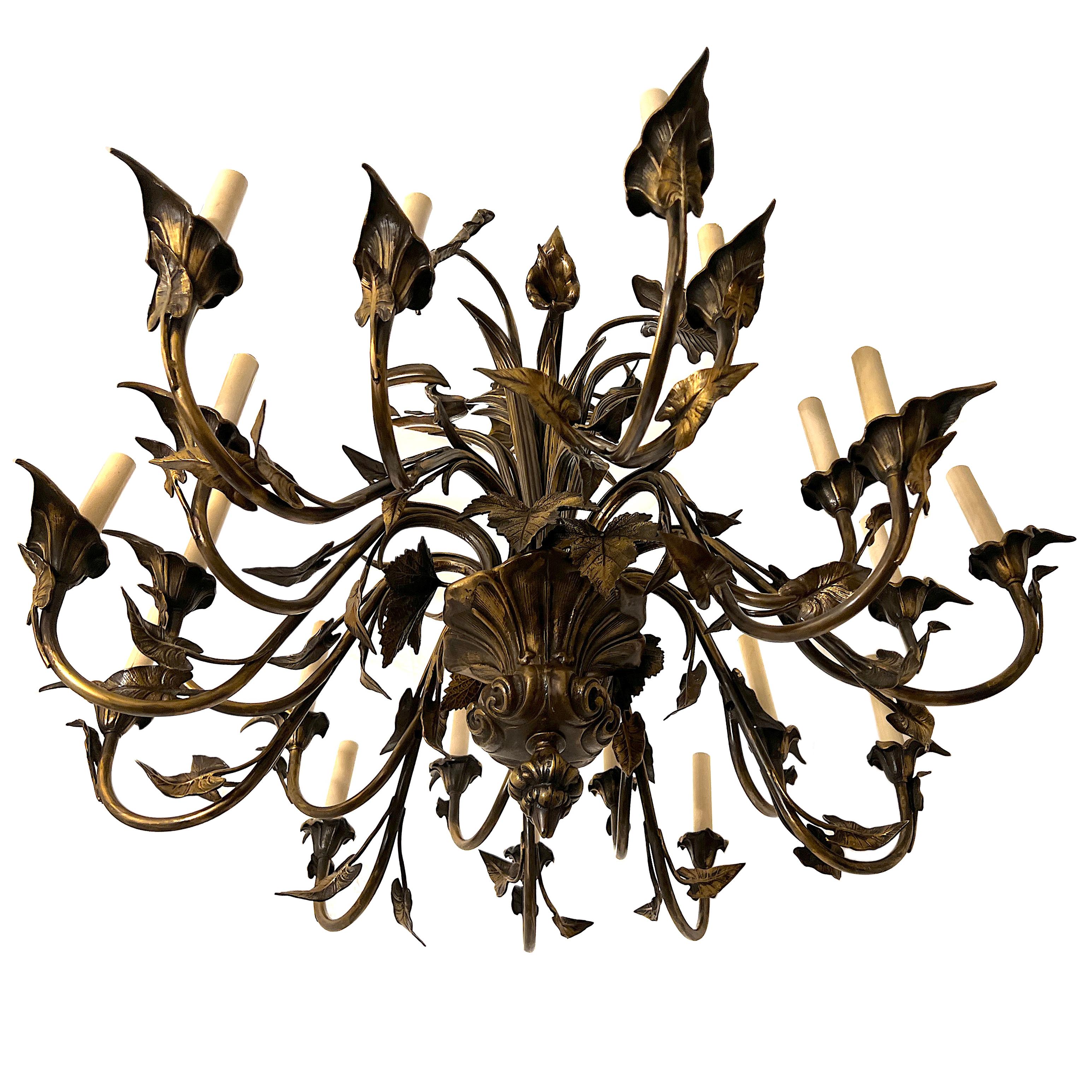 A  circa 1920s French calla lily design chandelier with 20 lights and with original patina. Cast bronze.

Measurements:
30 min. drop.
38