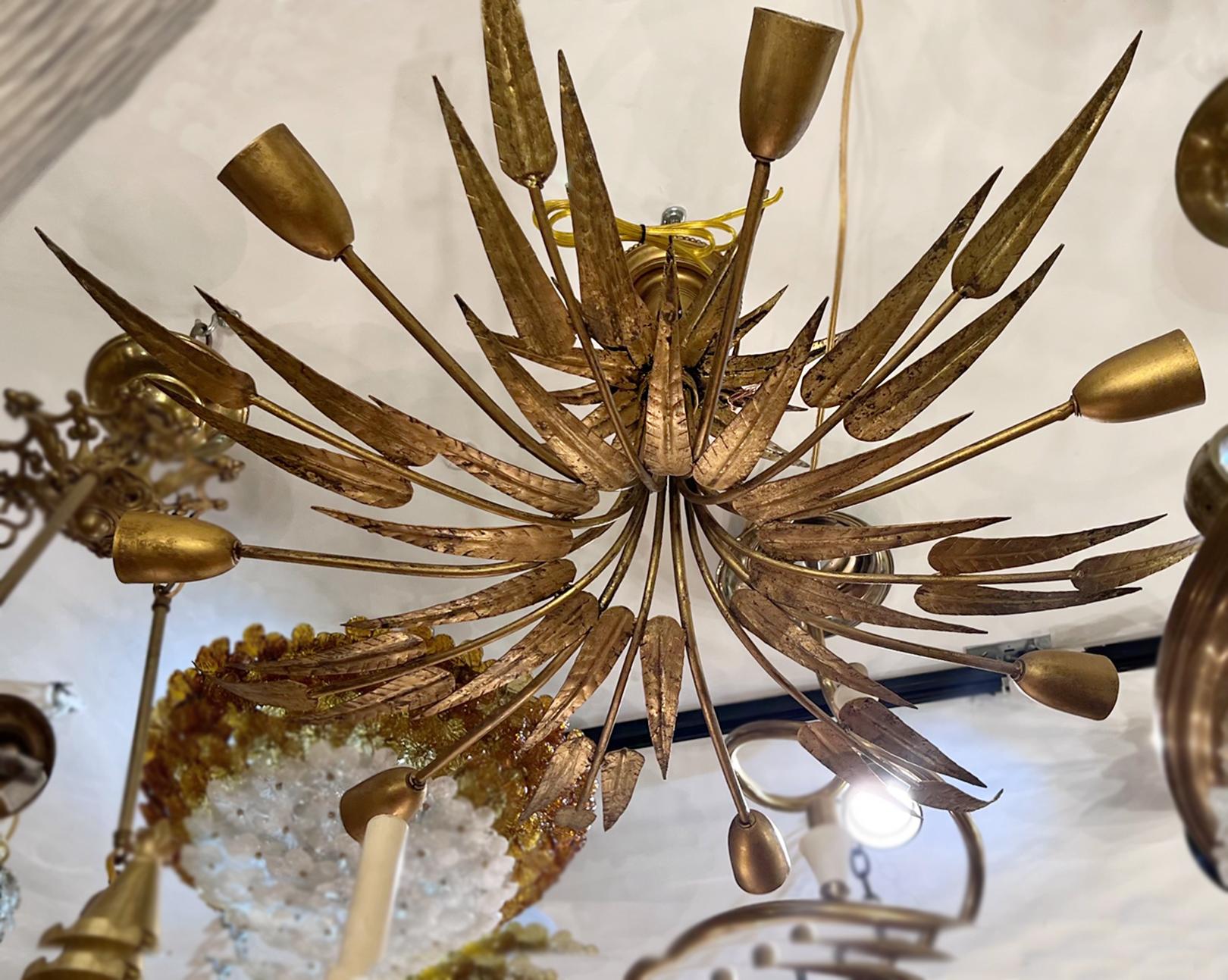 A circa 1960's Italian gilt metal light fixture with foliage motif with 7 candelabra lights.

Measurements:
Height of body: 15