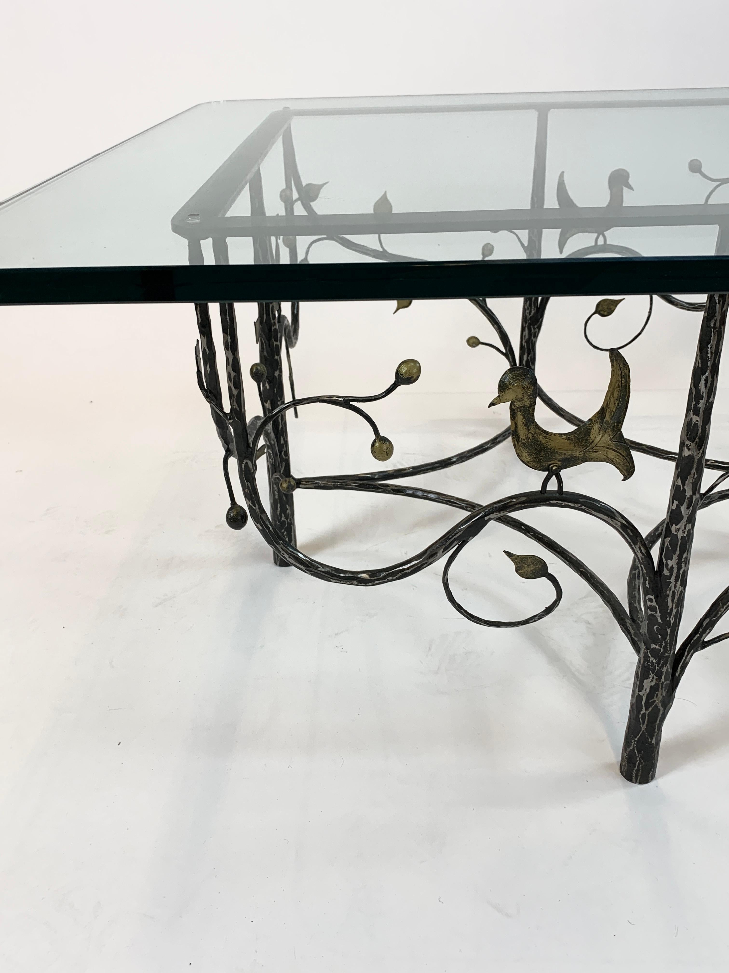 A bird and branch form rectangular cage-style cocktail table, with hand forged leaf patterns and bird on branch motifs. 

Bears similarity to work by Ilana Goor.
