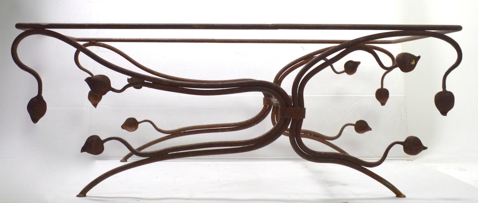 Whimsical stylized foliate wrought iron coffee table. Probably the best iron work we have seen in a long time, very high quality metalwork, unusual form, with great surface rust patina. Originally this table probably had a glass top, we do not