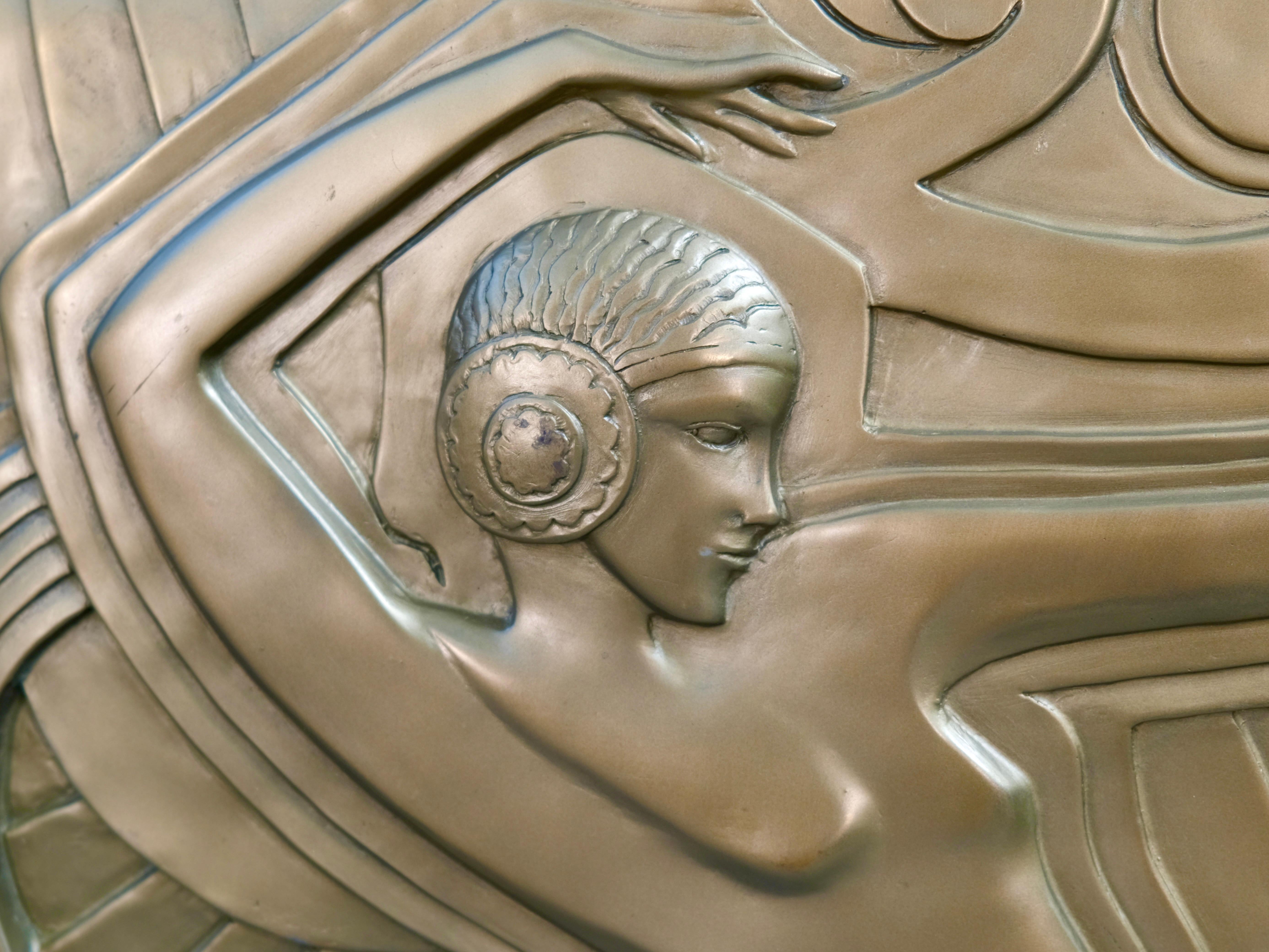 Golden wall plaque made after the model that decorates the facade of the revue theater “Folies Bergère” in Paris. This meter-high relief dates from 1926, by the French architect and designer “Maurice Picaud”, called “Pico”. The depicted dancer could