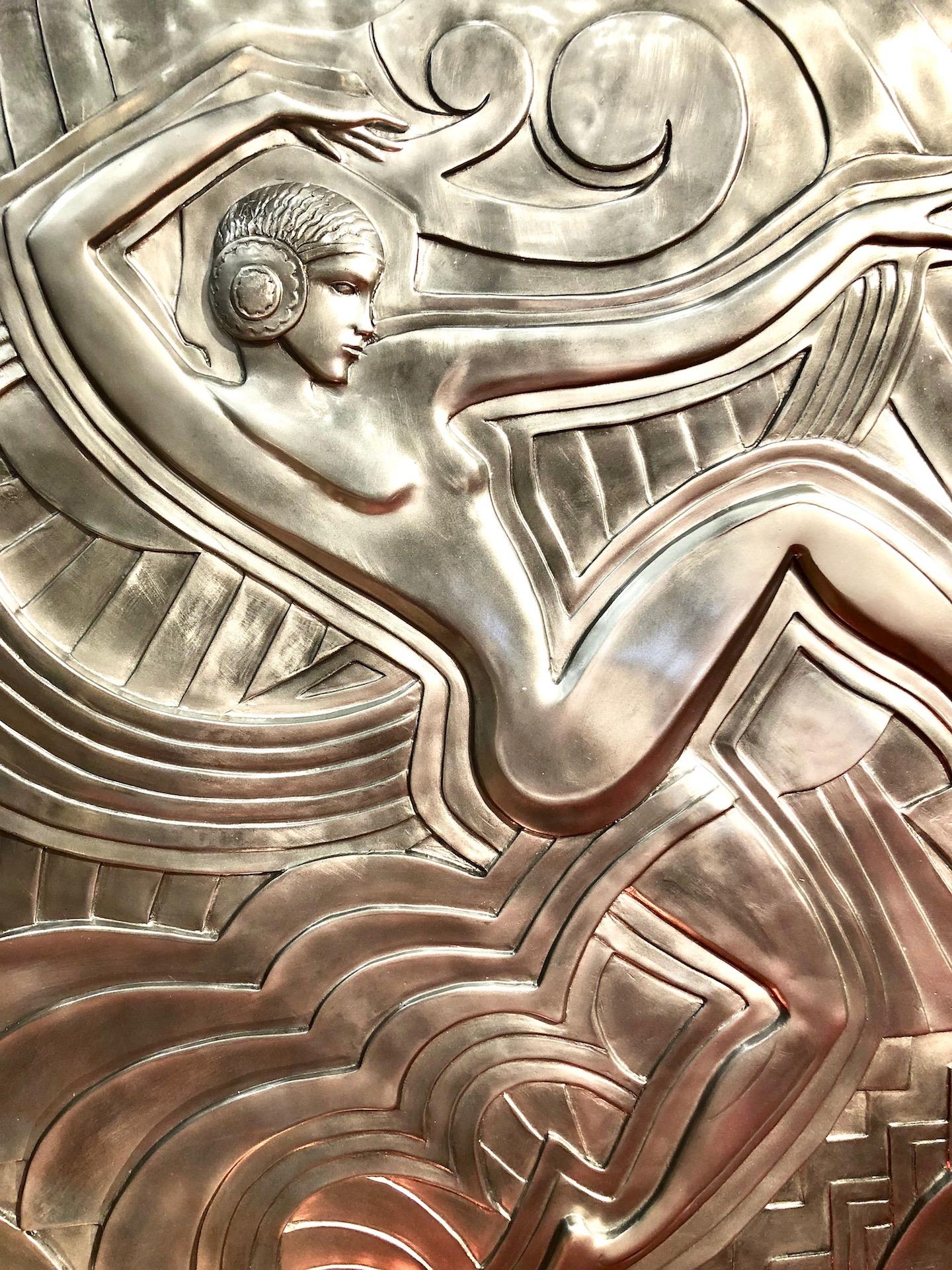 Silver colored wall plaque made after the model that decorates the facade of the revue theater “Folies Bergère” in Paris. This meter-high relief dates from 1926, by the French architect and designer “Maurice Picaud”, called “Pico”. The depicted