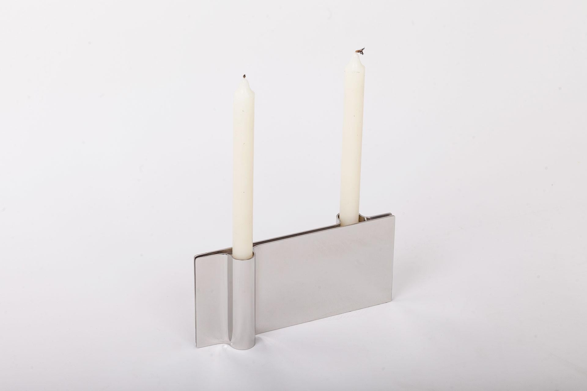 Folio steel candle holder by Mingardo
Dimensions: D22.5 x W2.2 x H11 cm 
Materials: Polished natural stainless steel
Weight: 1.5 kg

Also available in Different finishes: Polished natural copper, Polished natural brass, Polished natural