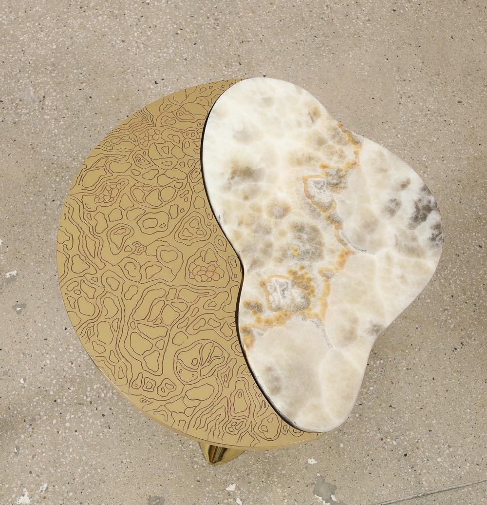 Cast & etched brass, onyx. Polished, cast brass free-from base with acid etched brass top and amorphic onyx slabs.   **These tables are recommended for use on hard-surface floors such wood or stone floors.  Some carpets pose stability issues and