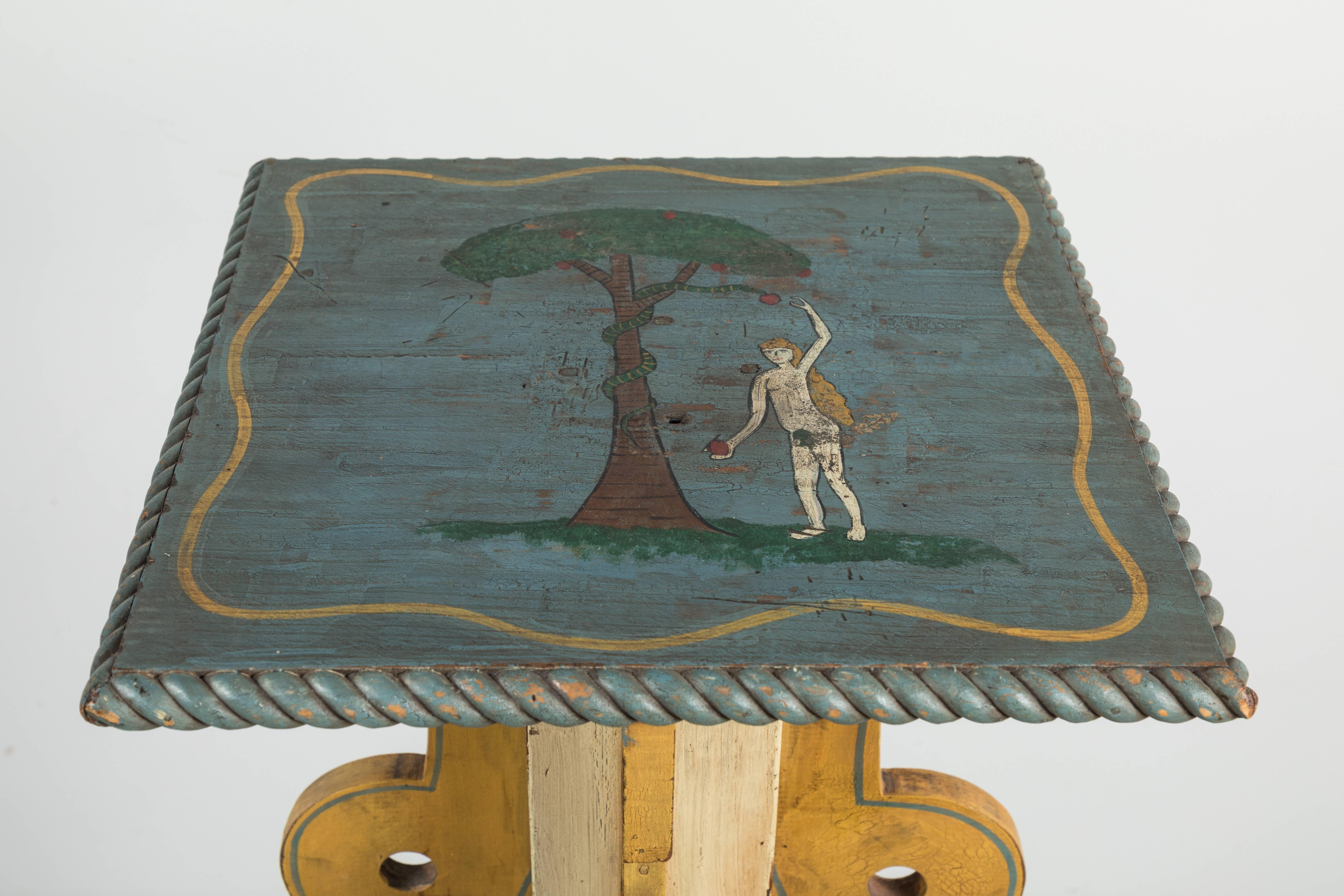 Fantastic hand-painted and carved lodge piece from the Midwest. Painting depicts Eve picking the apple from the snakes mouth. The Stand has a hand-carved snake that wraps around the base. Most likely an Odd Fellows or Masonic Lodge ritual table.