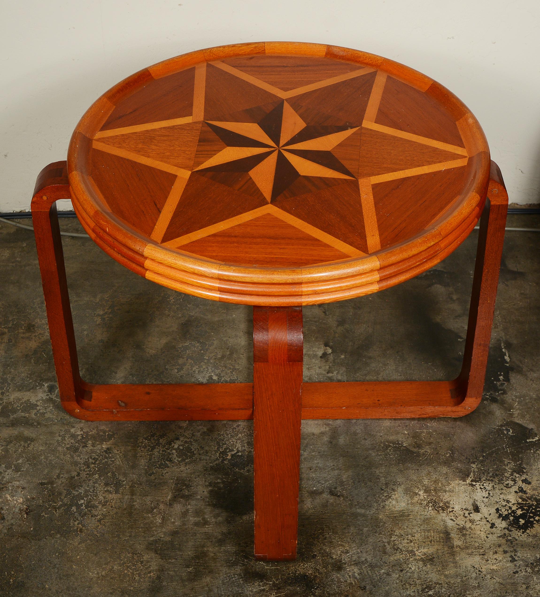 Art Deco Folk Art mahogany end table. This table probably dates to the 1940s or 1950s and was made by someone with better than average woodworking skills. The majority of the table is made with mahogany with walnut and maple inlay on the top. The