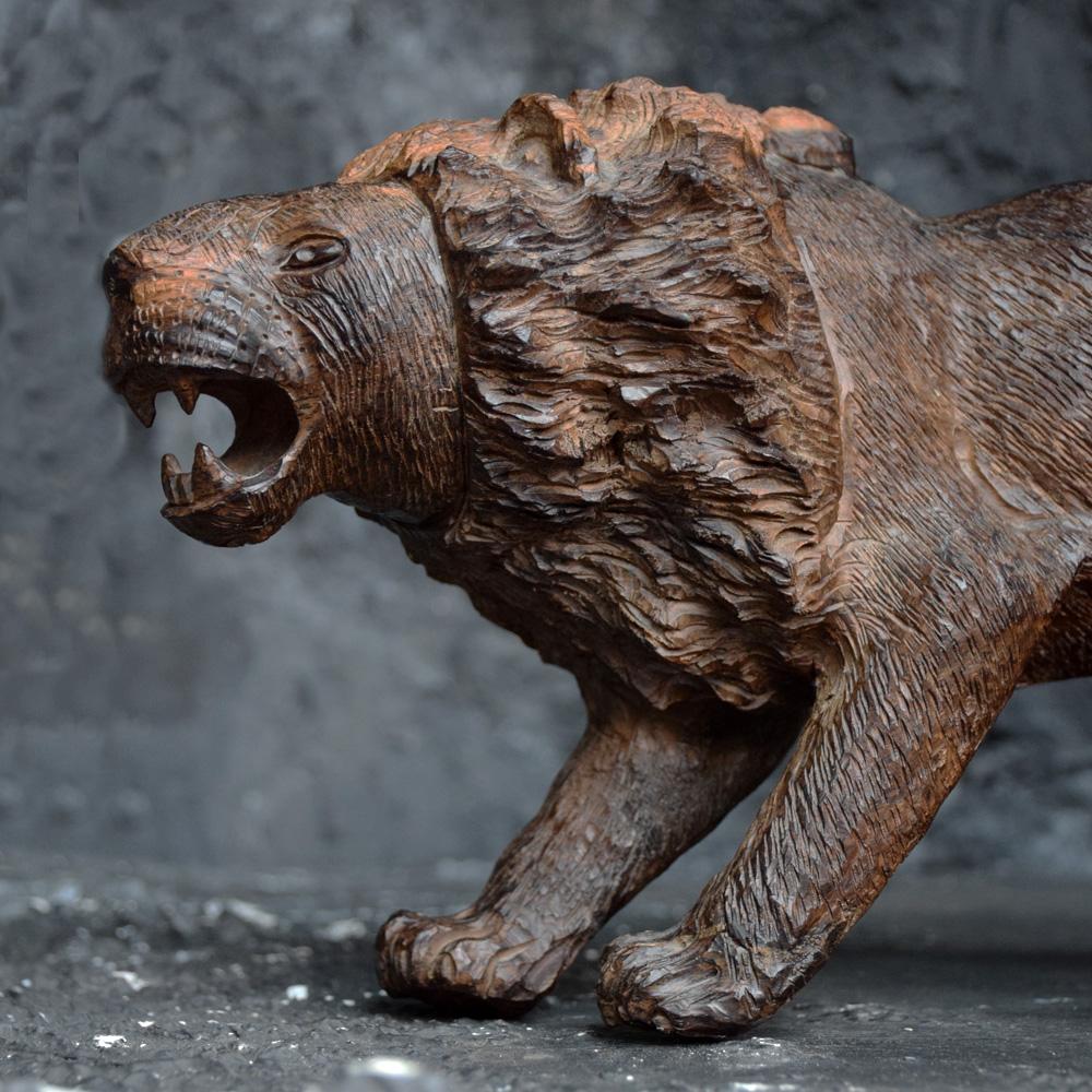 An unusually detailed example of a mid-20th century Folk Art lion figure. Unique in its formed with one rear leg raised as if it has a thorn in its foot. The etching across the surface of this statue is well crafted and detailed, a very tactile,