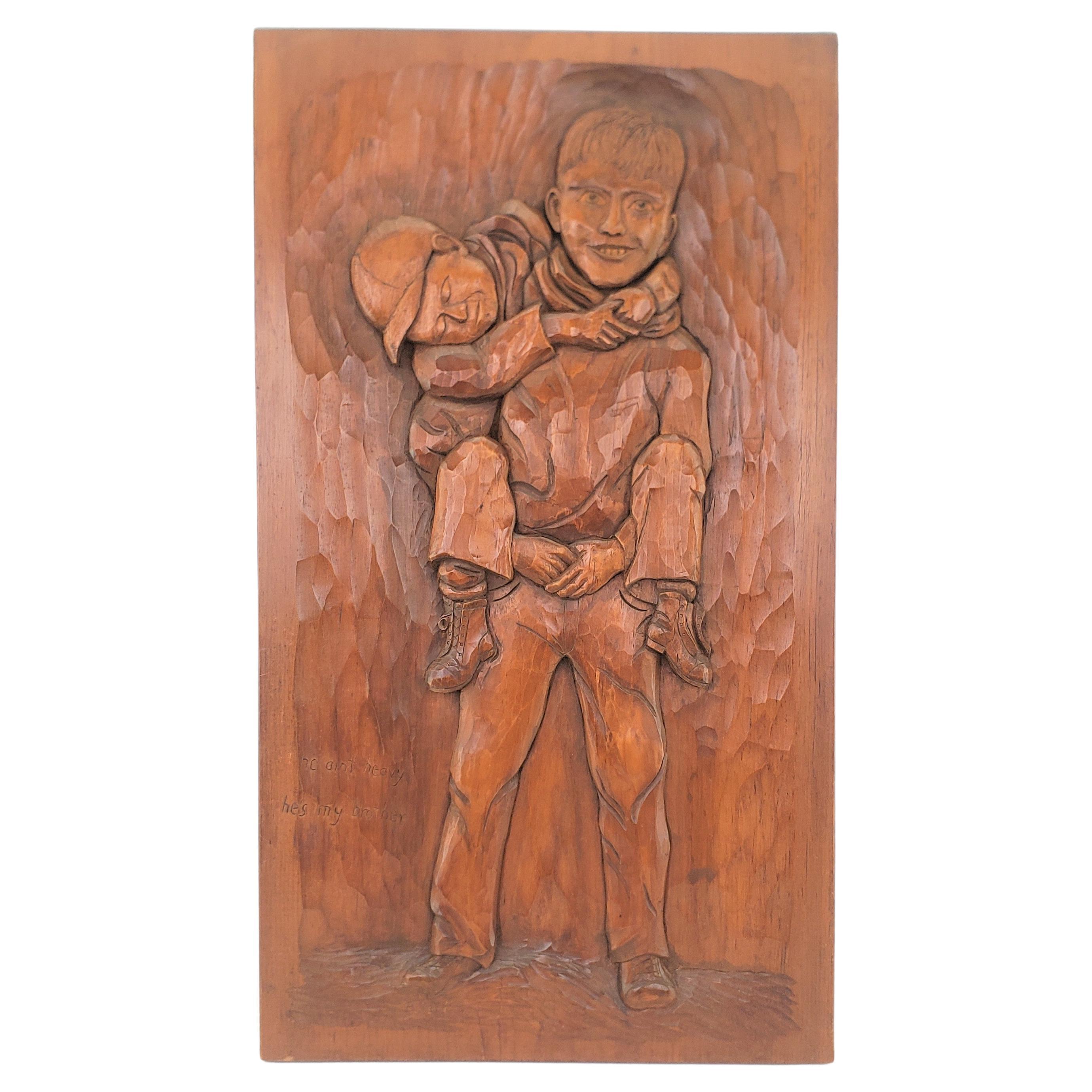 Folk Art Carved Panel of Two Brothers Titled: "He Ain't Heavy, He's My Brother" For Sale