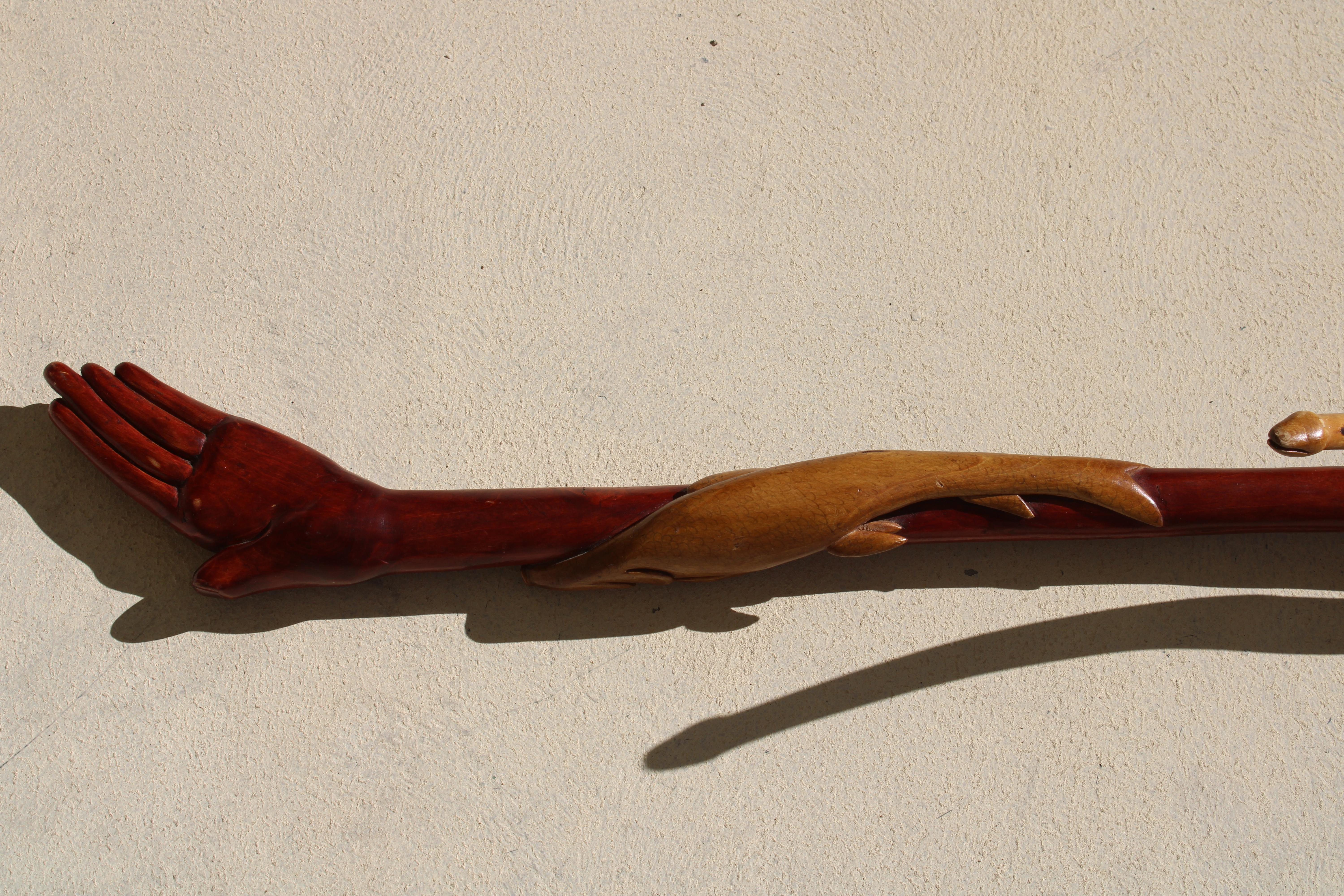 Folk Art carved walking cane with hand, 2 snakes and fish. Cane measures 7