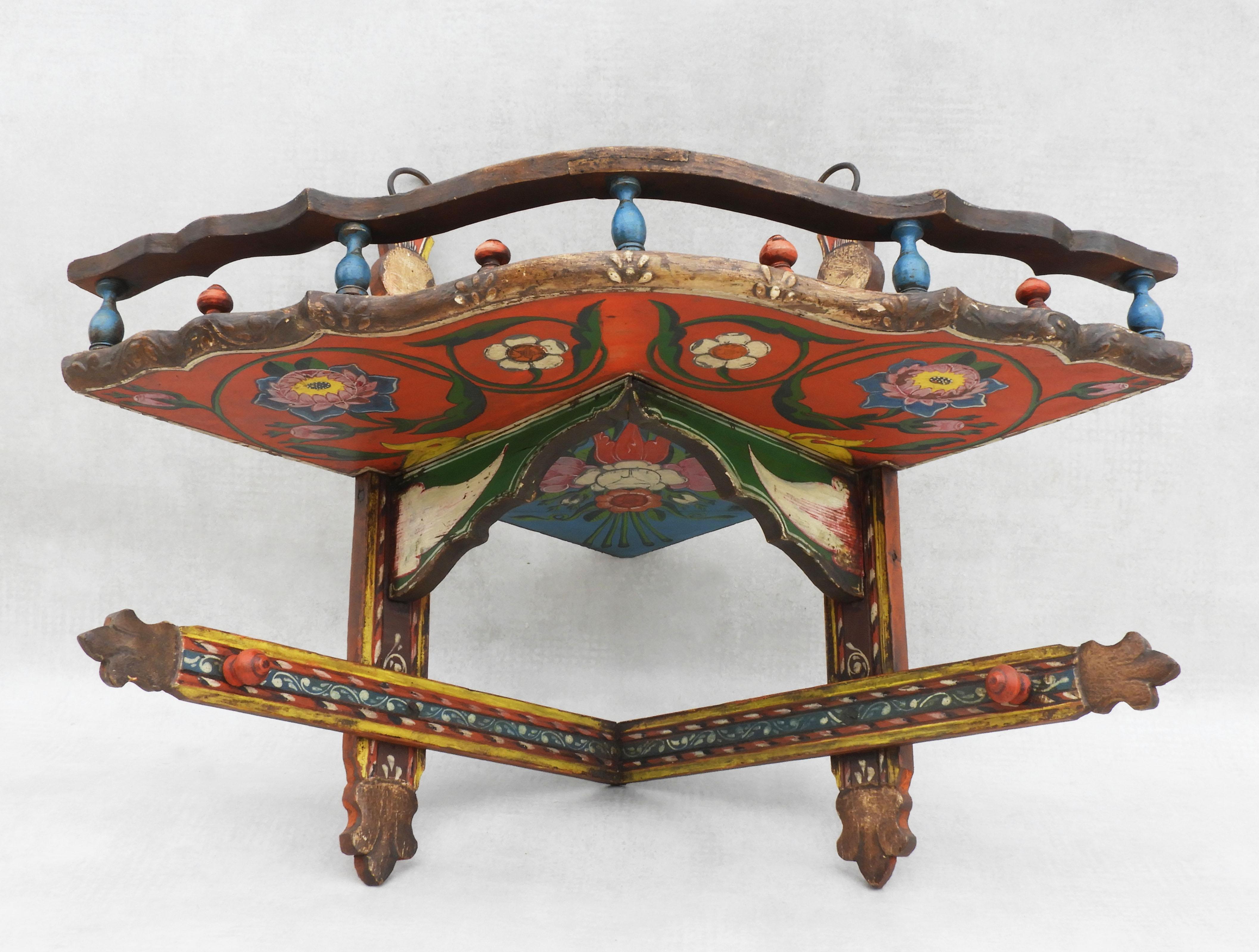 Charming hand-painted Folk Art corner shelf from Eastern Europe c1900.
A decorative display piece in a vibrant colourful floral theme with a galleried niche shelf. Wear consistent with age and use, lghtly distressed but in overall good condition.