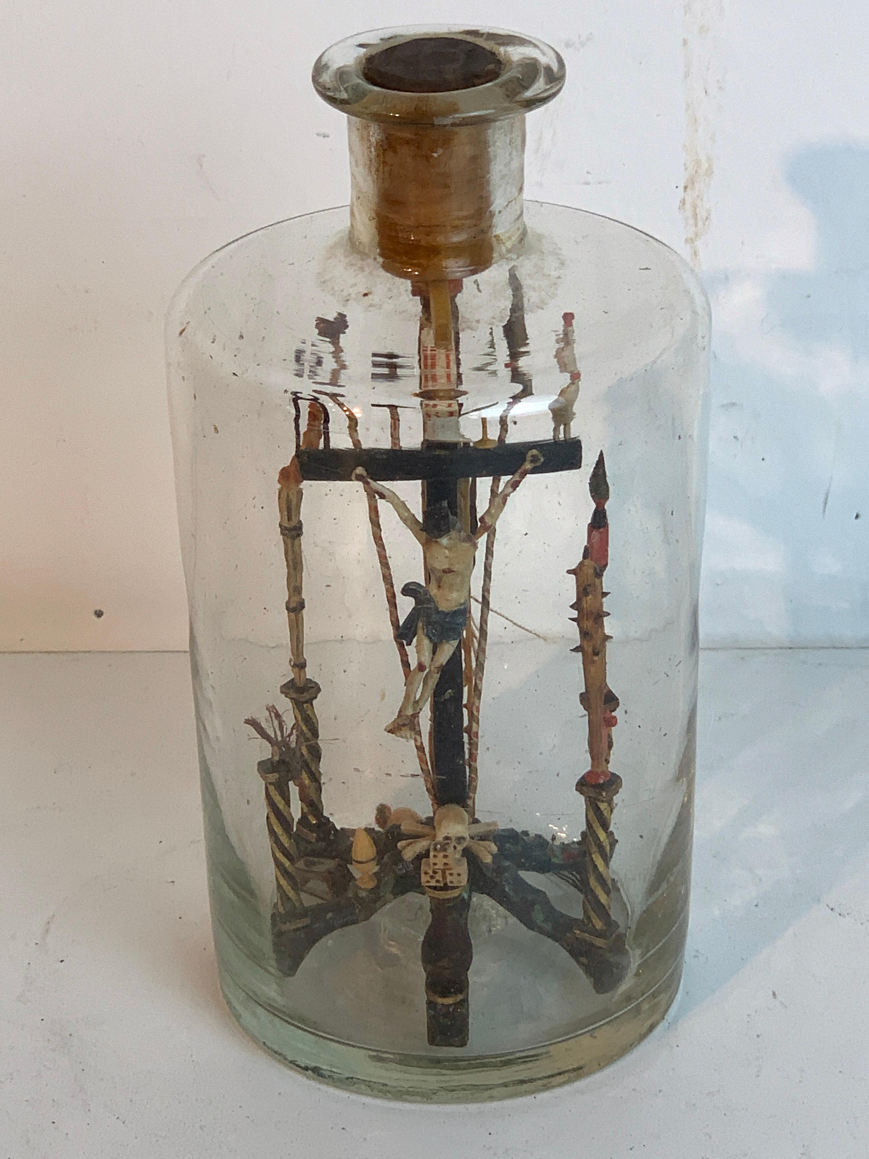 Folk Art Crucifixion scene in a bottle, intricately detailed carved and polychromed wood crucifixion with numerous elements of the passion of Christ.