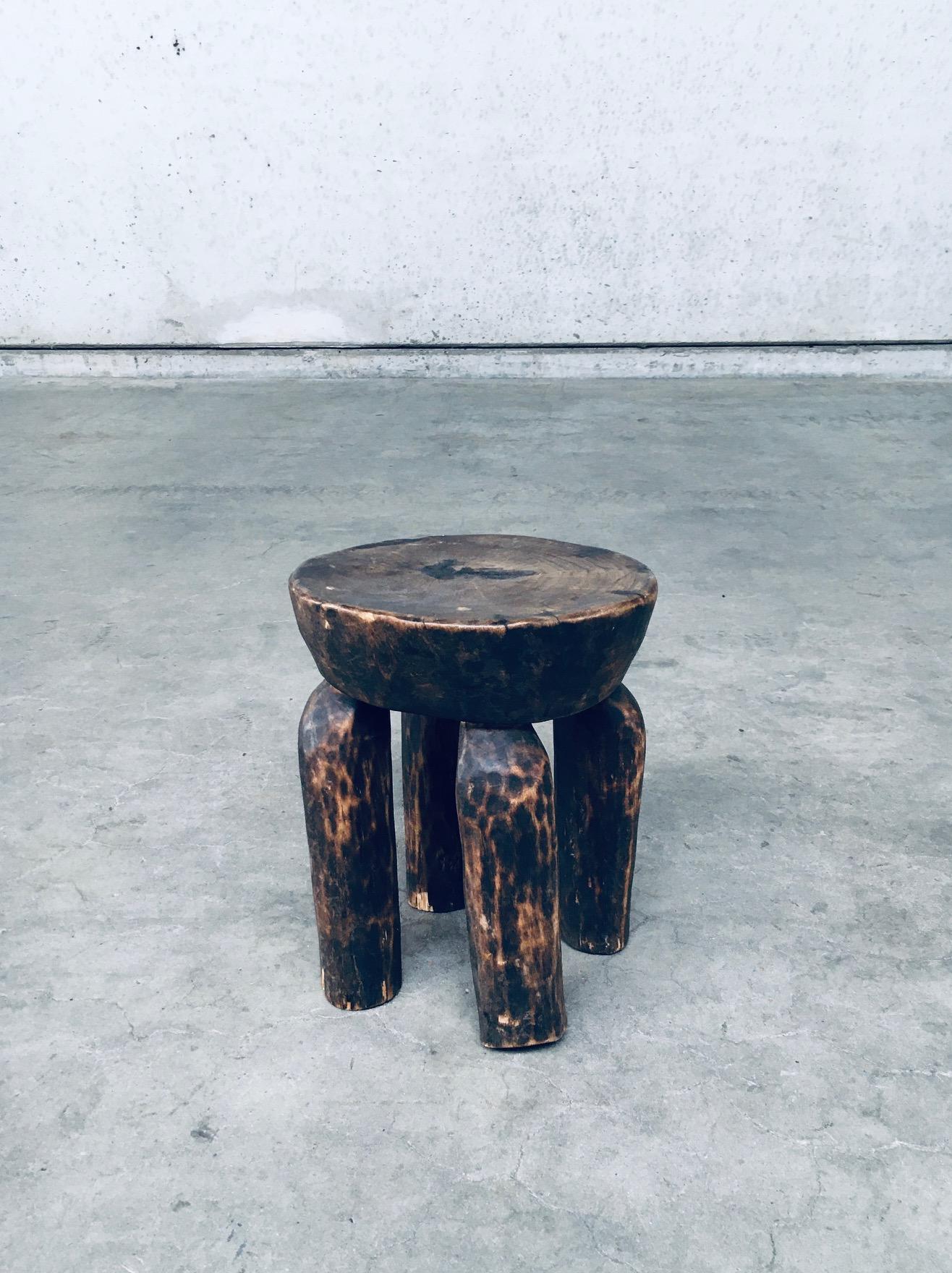 Vintage Folk Art Dogon African Low Wooden Stool. Made in Mali, 1920's period. Made by the Dogon Tribe / craftsman. Solid palm or local wood hand carved stool with nice patina. This comes in good condition with some small damages, which are normal