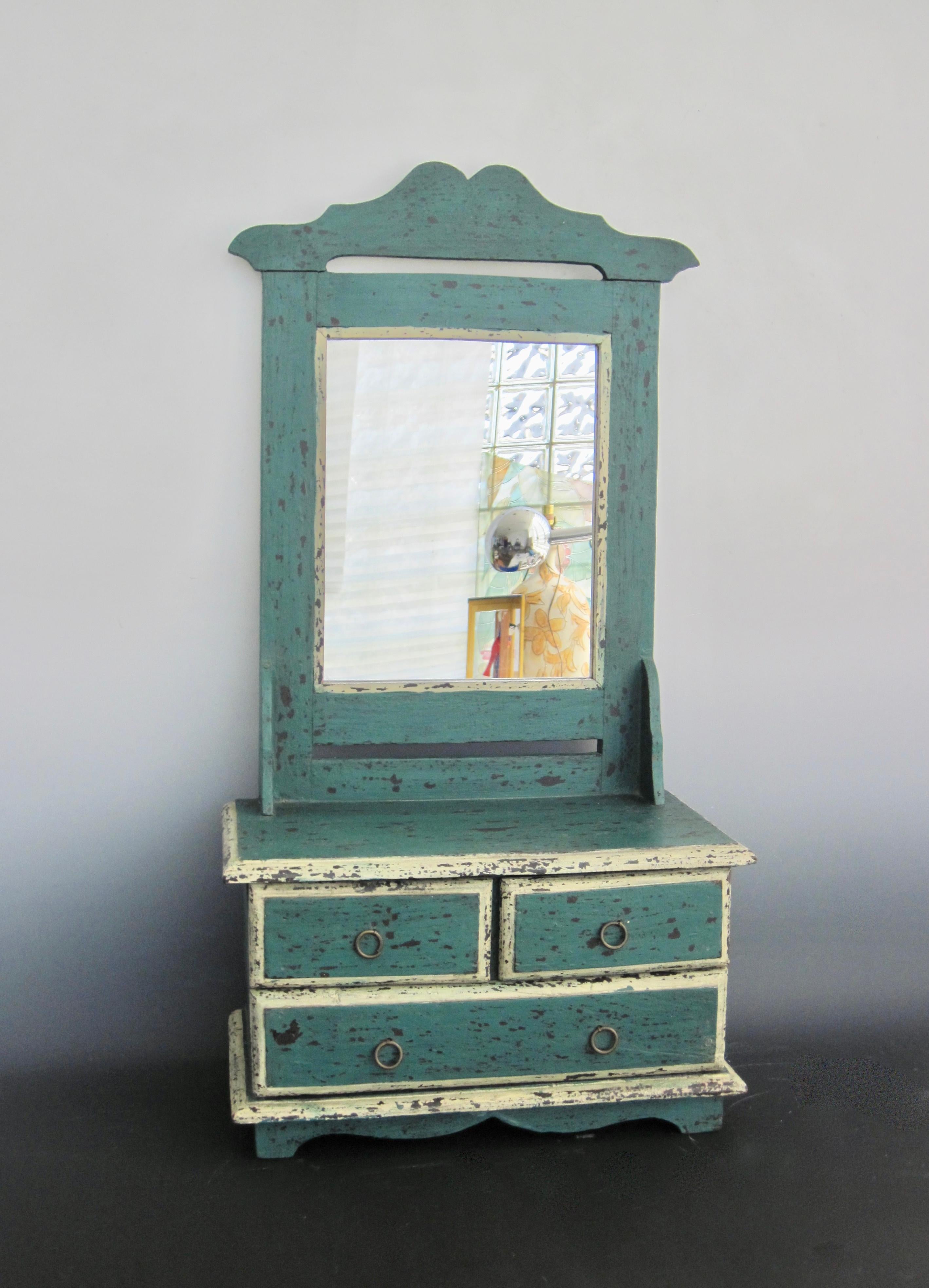 Early 20th century Folk Art dressing table mirror in the original paint - teal green over black with white trim. The distressed surface paint reveals the black underneath creating a textural look and feel. Three drawers with round brass pulls