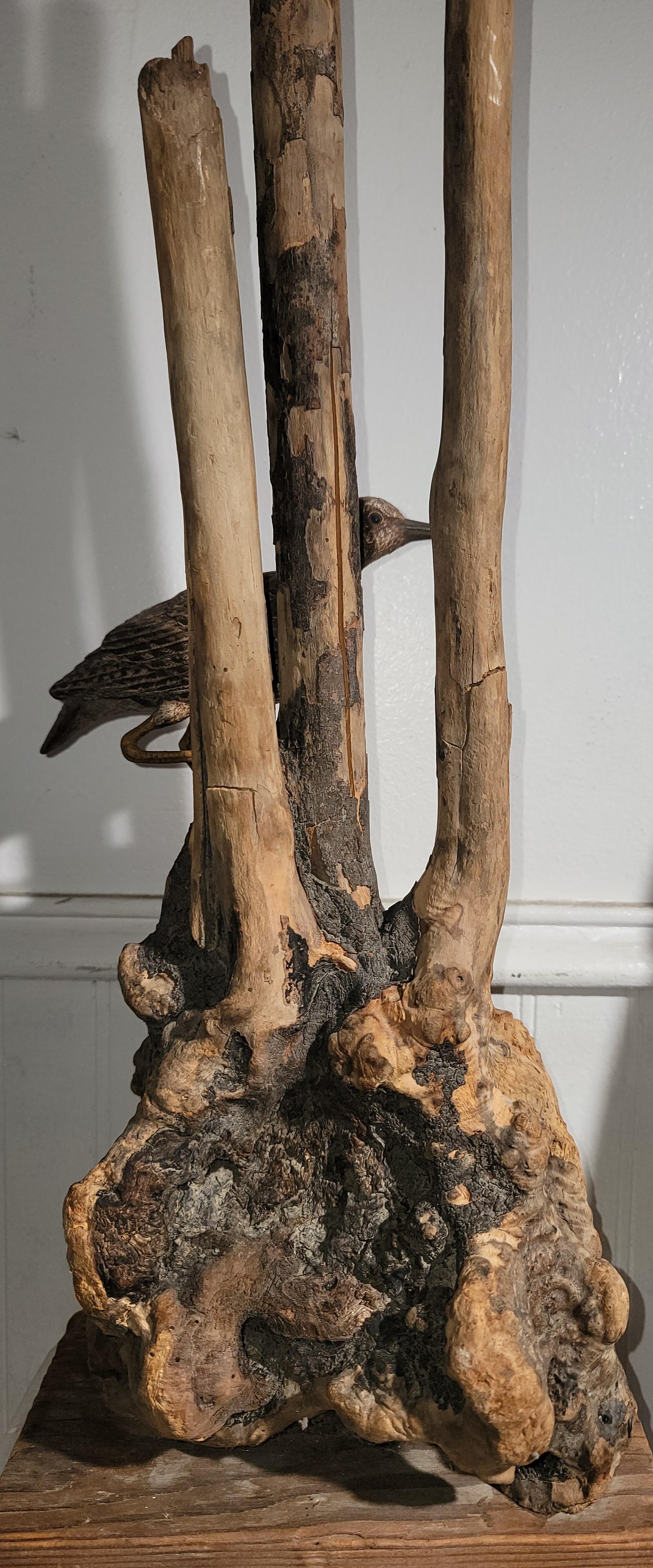 This folk art sculpture of drift wood and a plank wood base is all hand made.The bird is also wood carving added to the driftwood sculpture.The condition is very good as found condition.