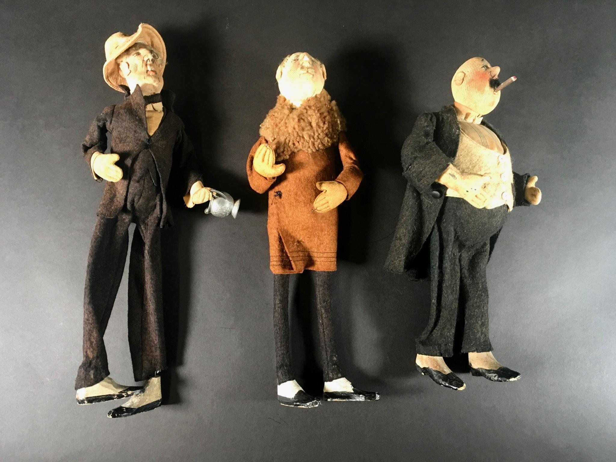 Collection of three Folk Art handmade male characters dolls. Each one a character in and of itself yet three together make quite a trio. I love the tiny details- a single spectacle on one, a single button, a cigar in another and  facial expressions