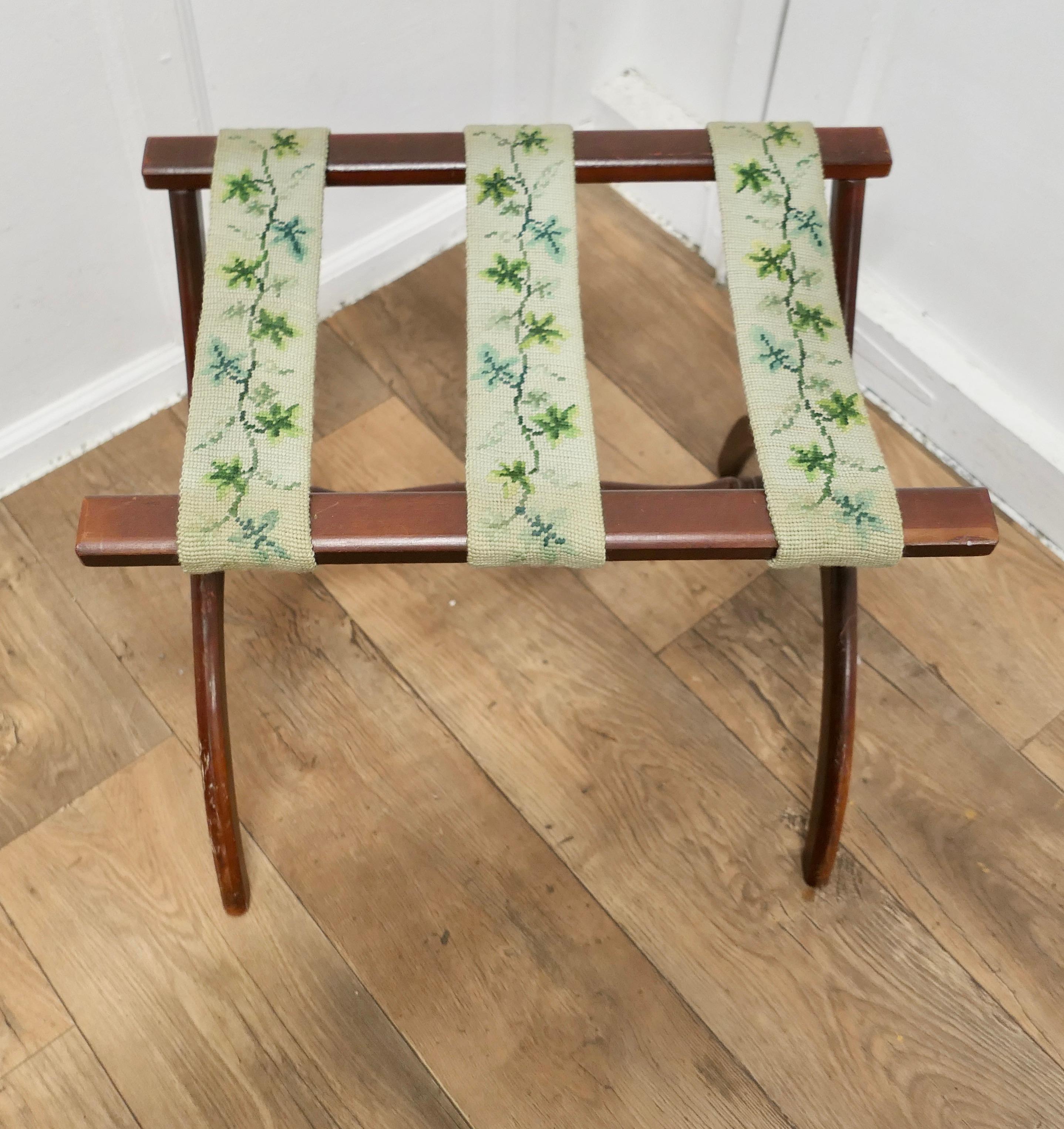 Folk Art Folding X Frame Luggage Rack

This is a good sturdy piece, it is made in beech and has a tough petite point embroidered webbing forming the top platform, the stand is robust and strong
The rack is 22” long, 15” wide and it is 19” high
SC101
