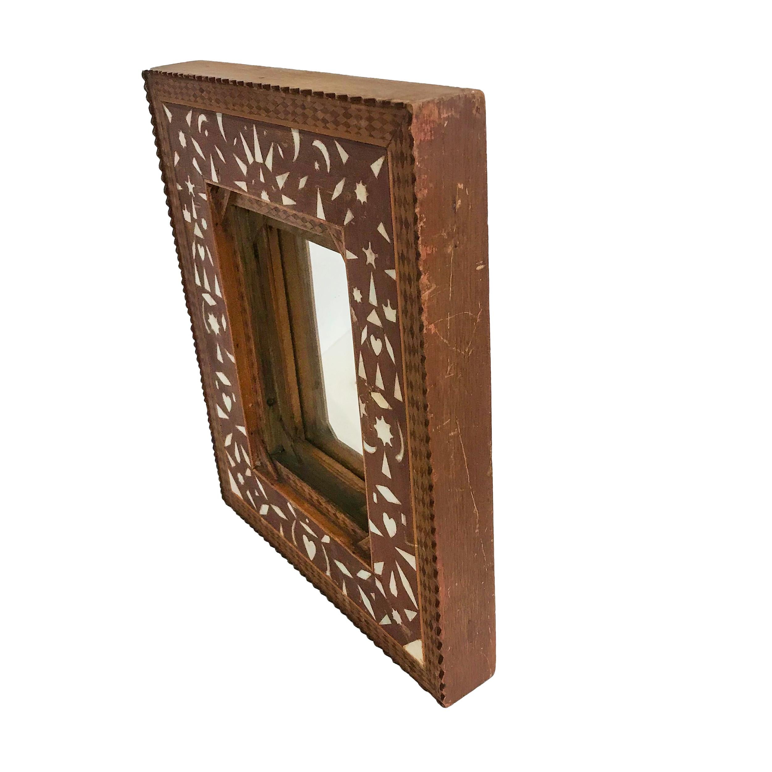 With a Tramp Art carved edge and mixed wood parquetry border, also with mother of pearl inlay, all in alligatored finish, circa 1880-1900.

Measures: 12 ½” x 10 ½” x 1 ¾”.
