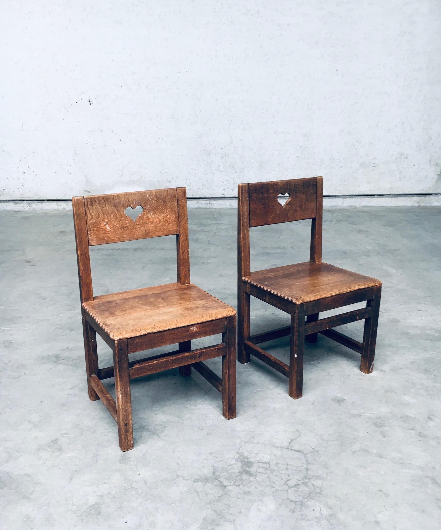 Vintage Folk Art Populaire Haagsche School Design Style Child Chair set. Made in the Netherlands, 1910's / 20's. Handmade and carved oak child chairs with a heart carved in the backrest and nice carvings at the edge of the seat. Beautiful in their