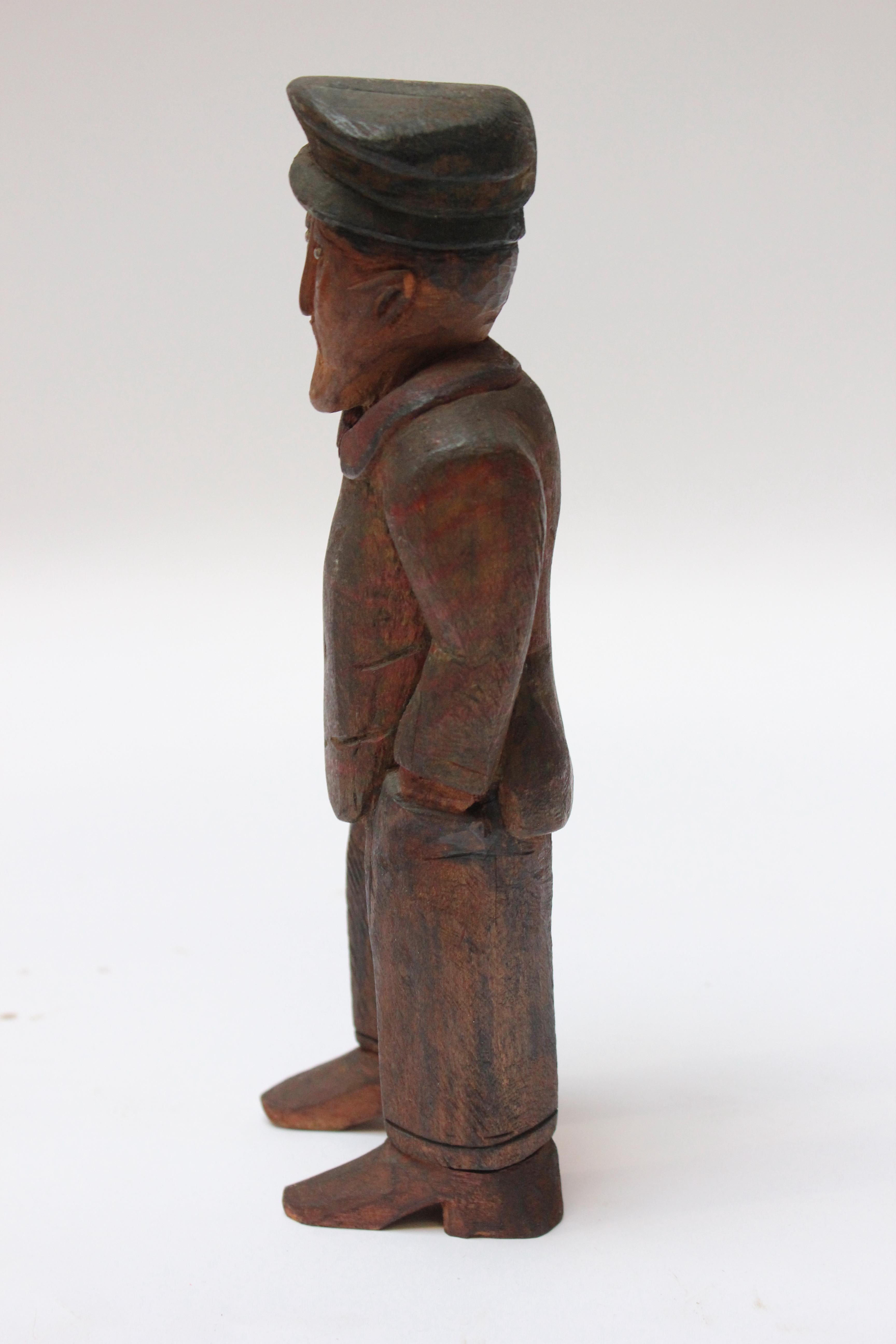 Charming folk art hand-carved and painted figure depicting a man with his hands in his pockets donning what appears to be a newsboy cap (ca. early 20th Century, USA).
Attractive colors employed, which were applied unevenly to the figure, nicely