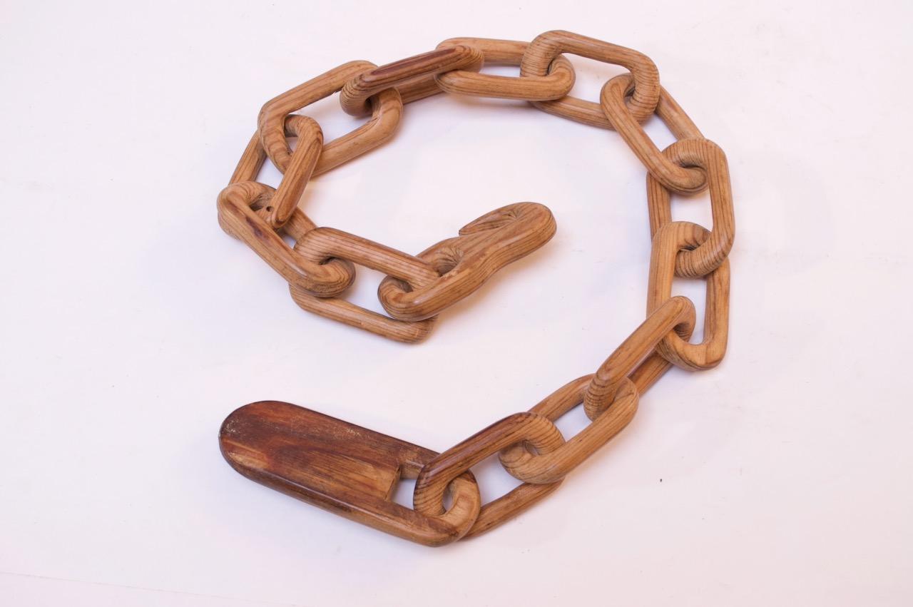 Nice, whimsical Folk Art chain whittled from one continuous piece of wood (spruce, in this case). One end features a hook, the other a clasp. The wood has a beautiful, varied tone; it is dark in places, and lighter in others, giving it a two-tone