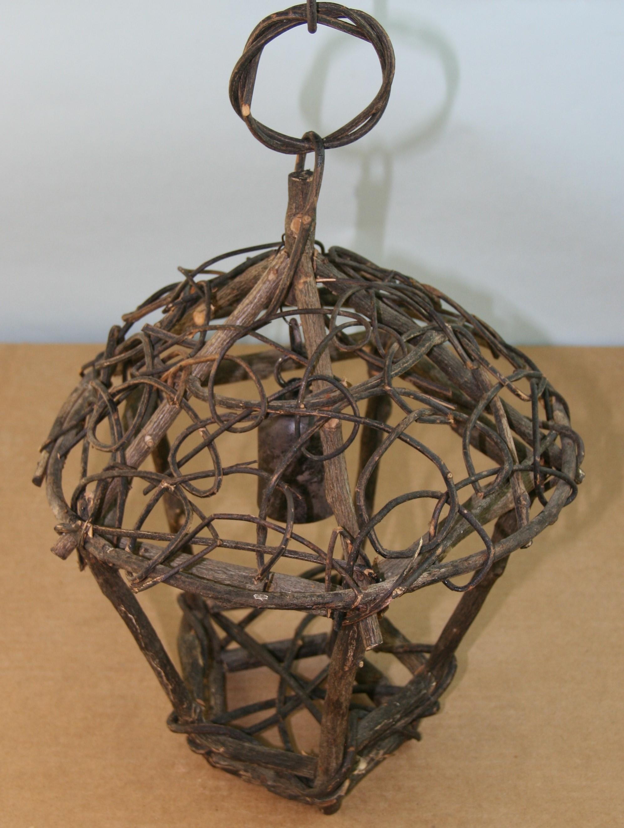 3-1025 Folk Art hand made twig lantern.
Take one 60 watt Edison based bulb
Measures: Height to top of loop 16