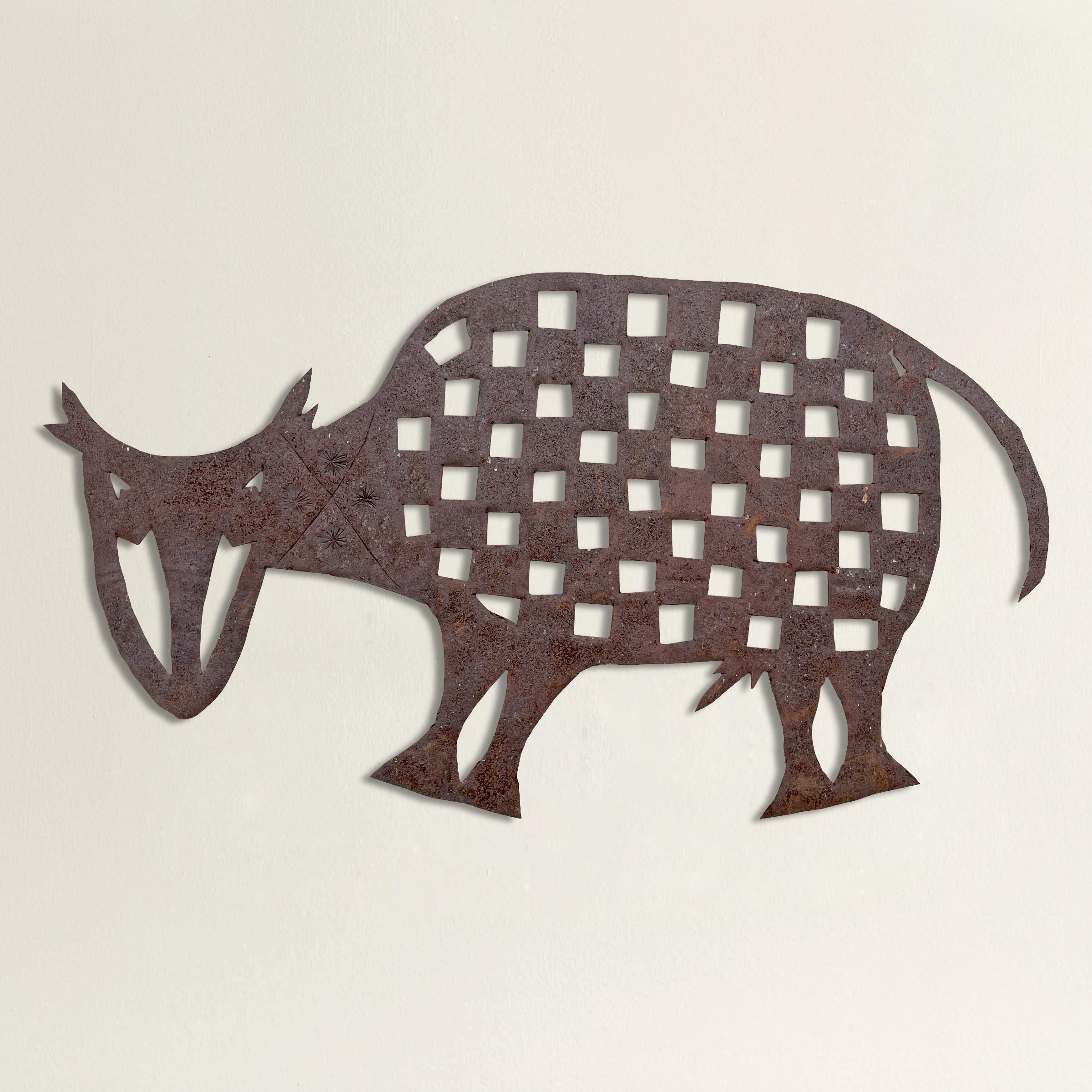 A whimsical American Folk Art iron sculpture depicting a bull with a checkerboard body and stamped starburst patterns on the neck. A custom steel wall mount is included.