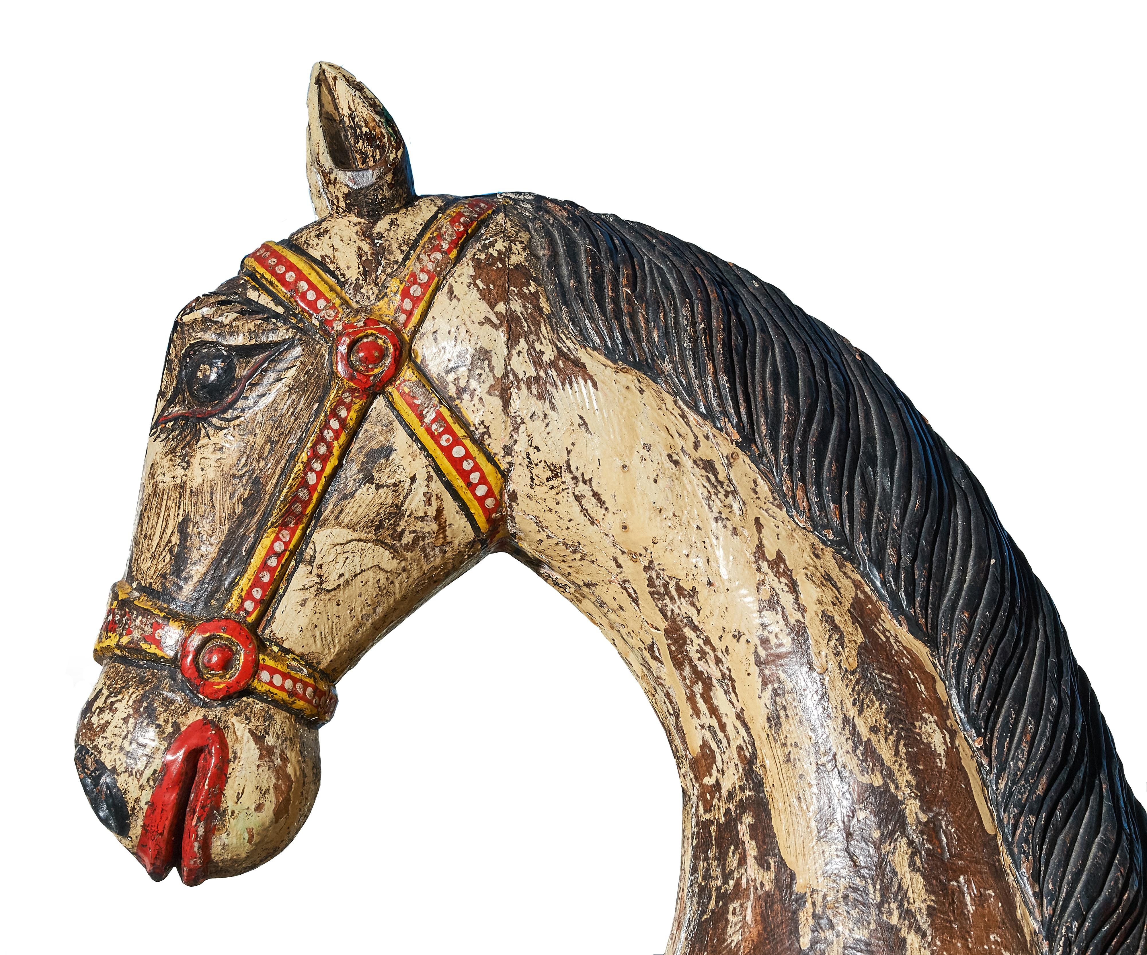 Large whimsical Folk Art horse on wheels. Great color and lots of personality. The horse is unsigned but we believe it to be Mexican from the decoration. Solid construction, hand painted and faux distressed this piece has loads of character.