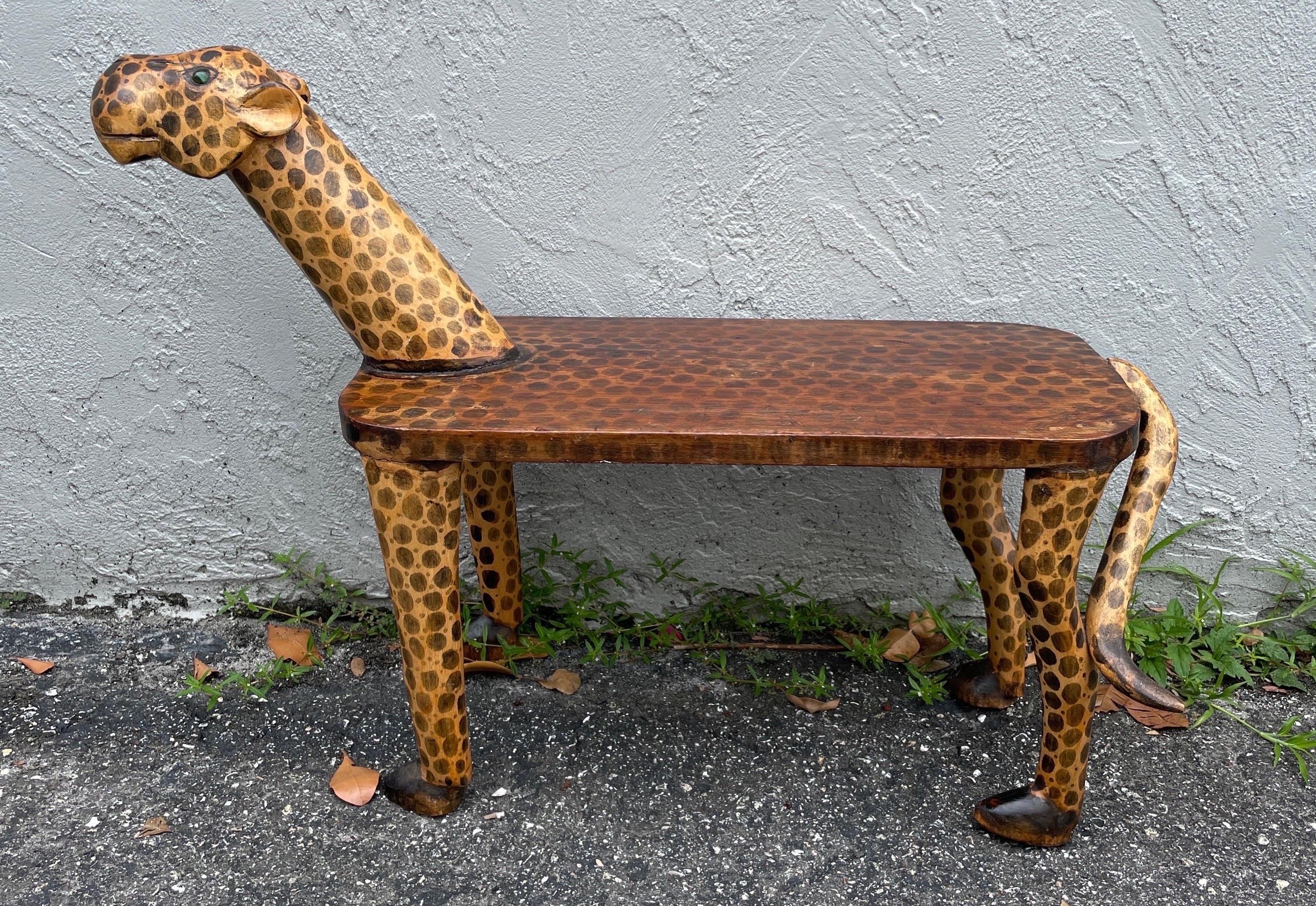 Vintage carved & hand painted Folk Art leopard bench with glass eyes.