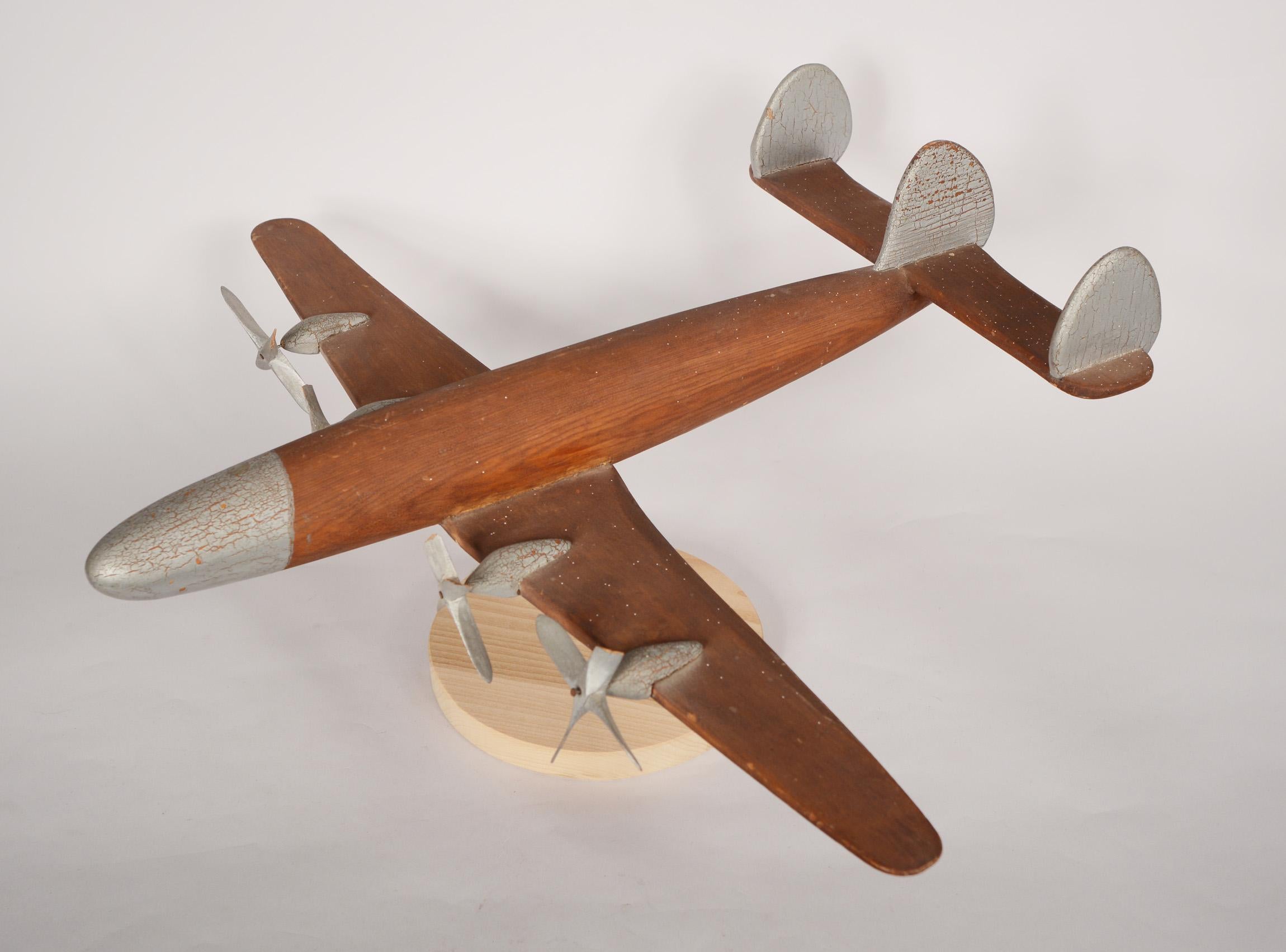 Large model of a Lockheed Constellation made by Charles Long. The airplane is made of redwood. The propellers are pine. Charles was a captain in the Army Air Corps and I believe later worked for Lockheed. There are some broken propeller blades and