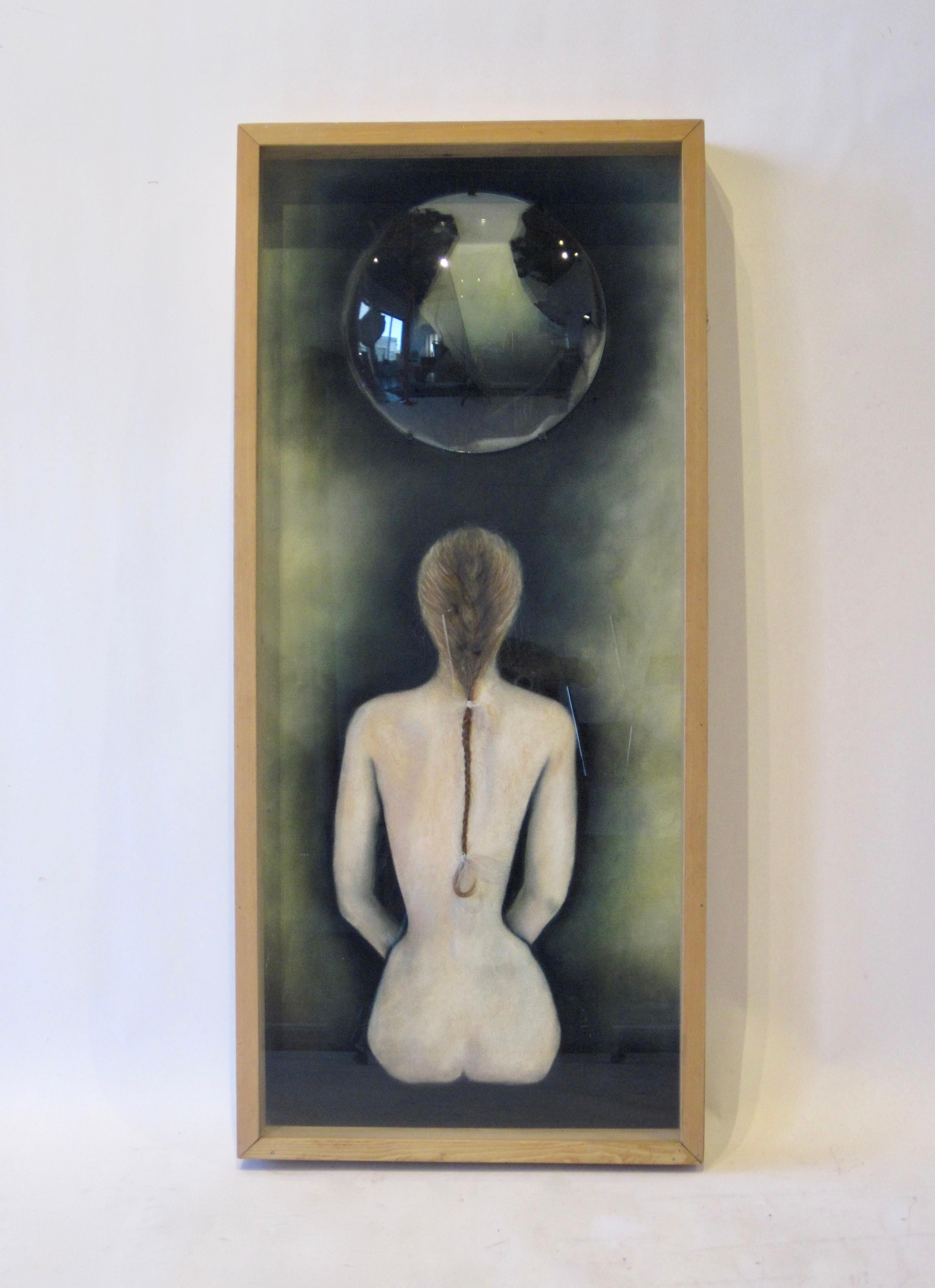 Folk art shadow box painting of a slender nude female form sitting under a full moon.  With a chiaroscuro effect and her backside to the viewer, this work has mysterious and dramatic feel. Her light hair which begins as a painting and becomes a long