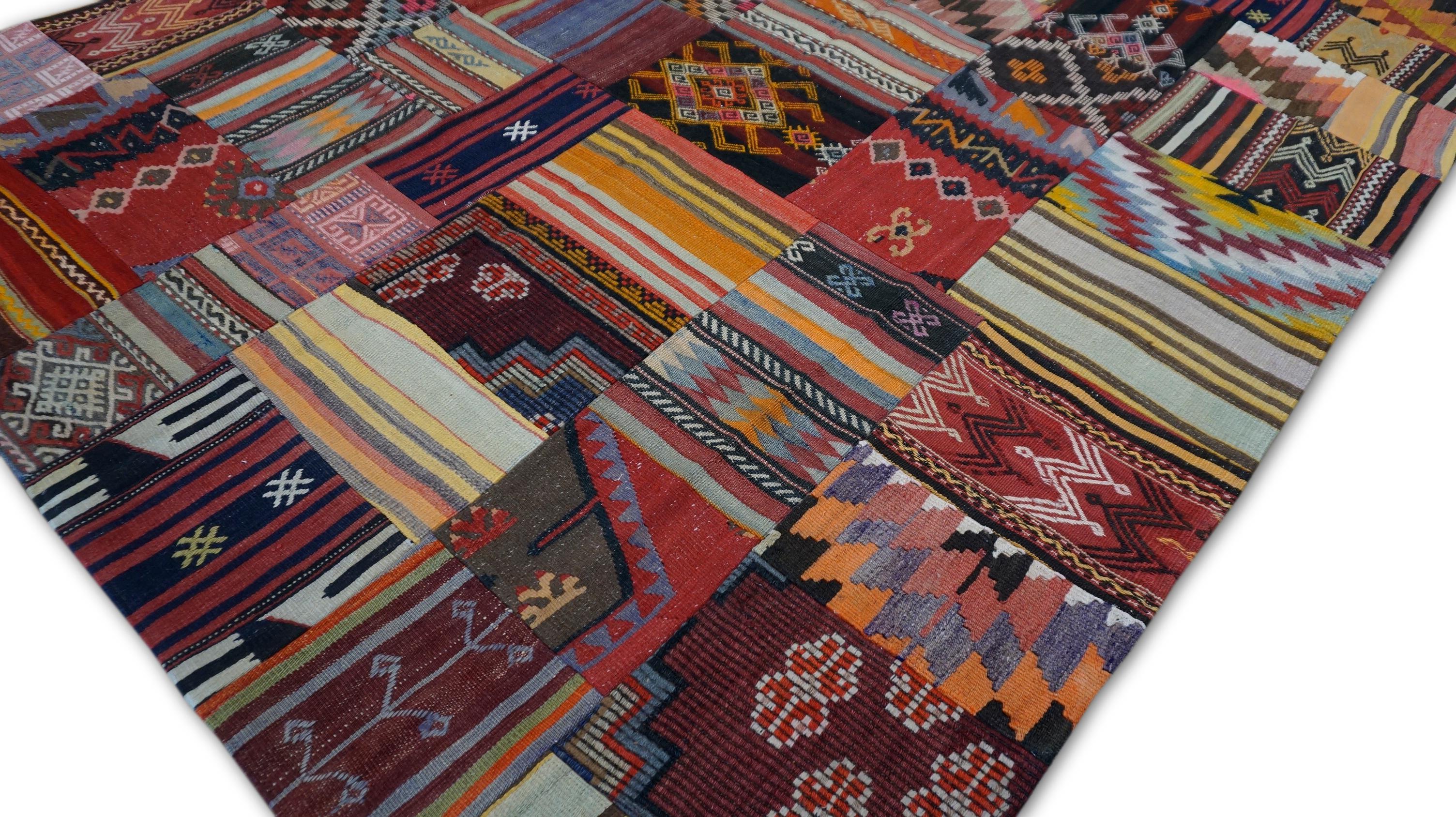 This vibrant handwoven wool patchwork rug is a joyful celebration of rich textile heritage. Expertly assembled from a curated selection of vintage fragments, each panel in this unique piece reflects the artisanal legacy of various nomadic tribes