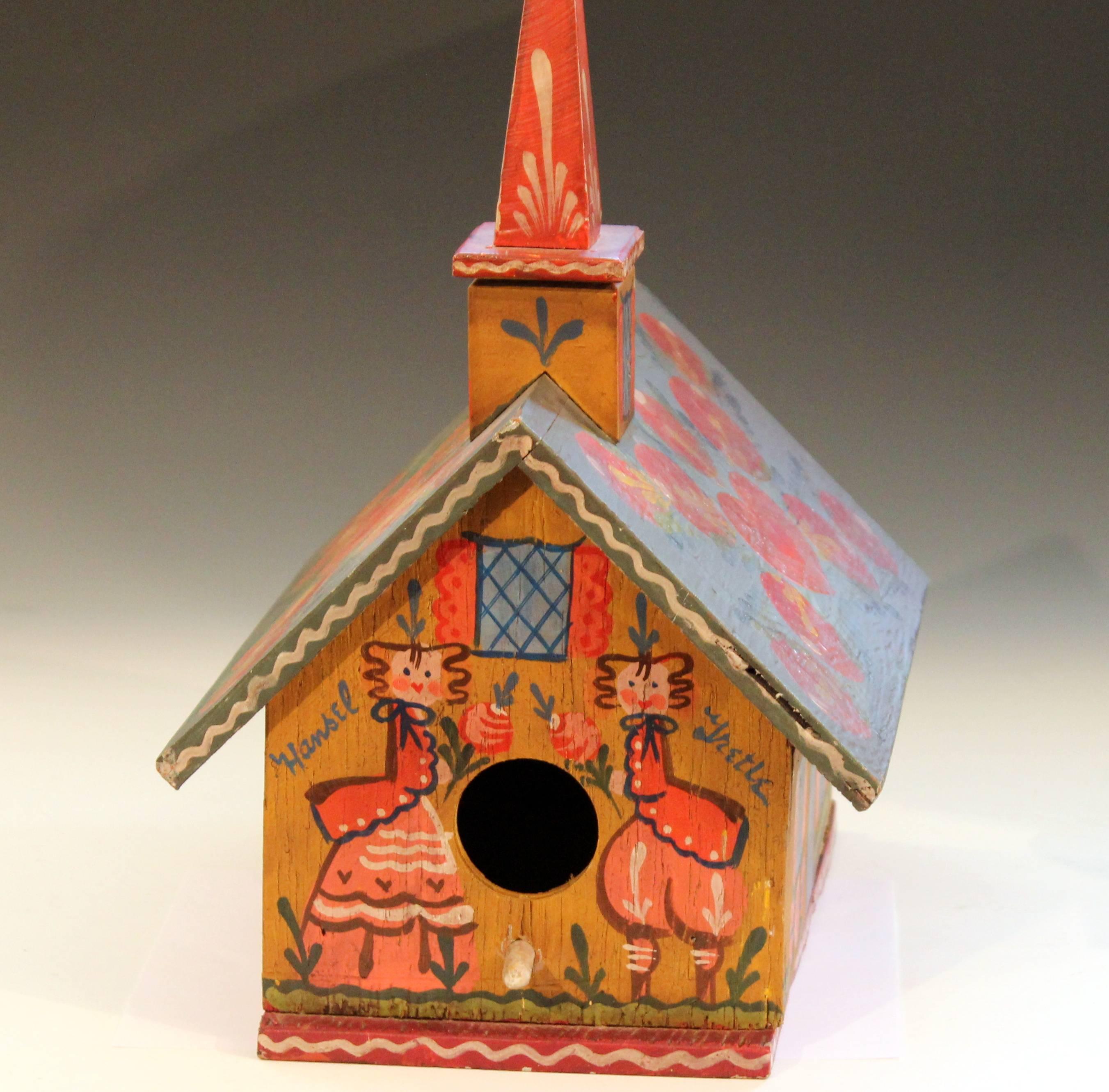 Vintage Folk Art painted birdhouse in Pennsylvania Dutch style with Hansel and Gretel theme, circa mid-20th century. Signed by renowned New England artist Nancy Whorf who learned the craft working with Peter Hunt. Measures: 17 1/4